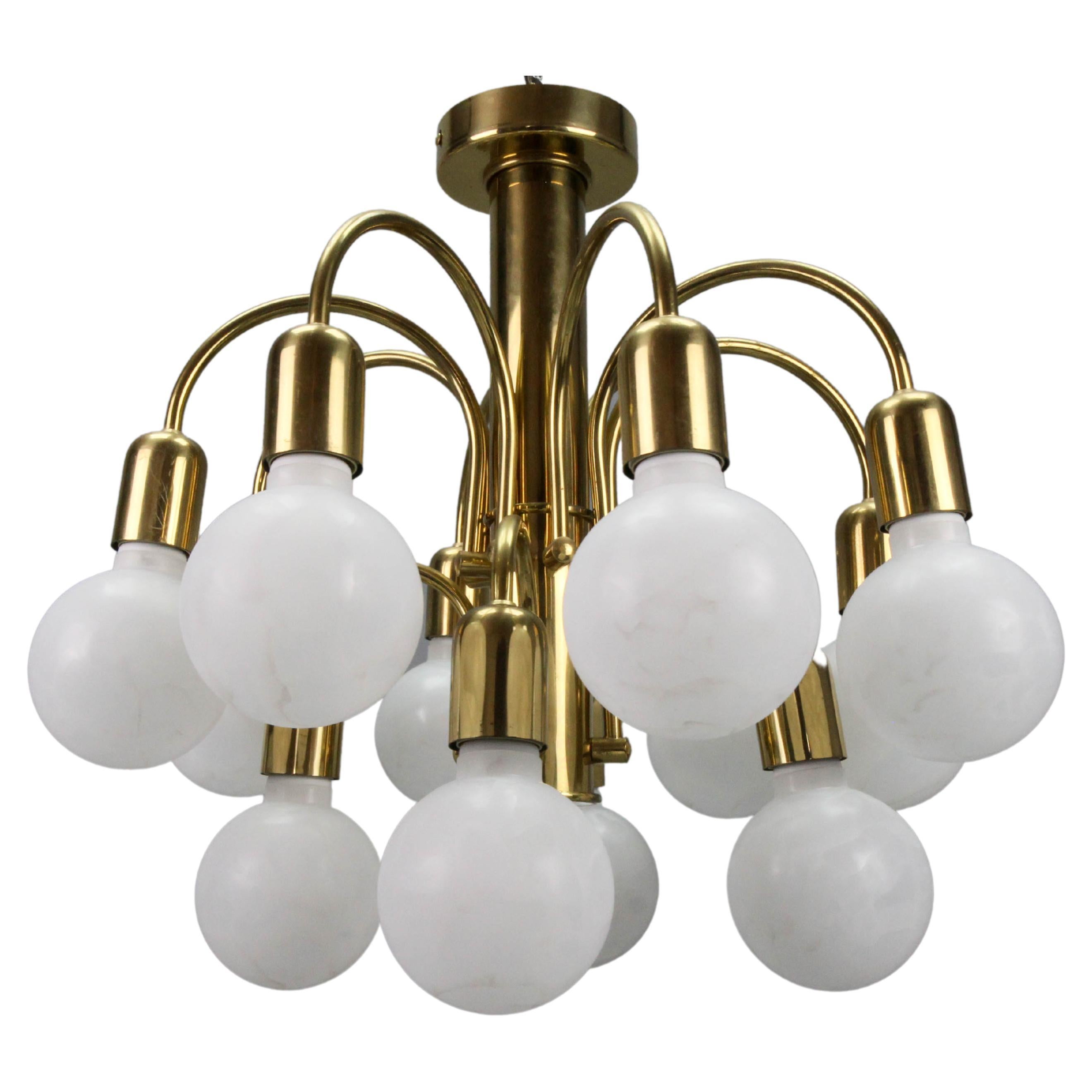 Mid-Century Modern brass twelve-light sputnik flush mount chandelier, the 1970s.
An elegant German Mid-century modern brass flush mount chandelier from the 1970s. Twelve sockets for E27 (E26) size light bulbs.
For the photo shoot, we used E27 (E26)