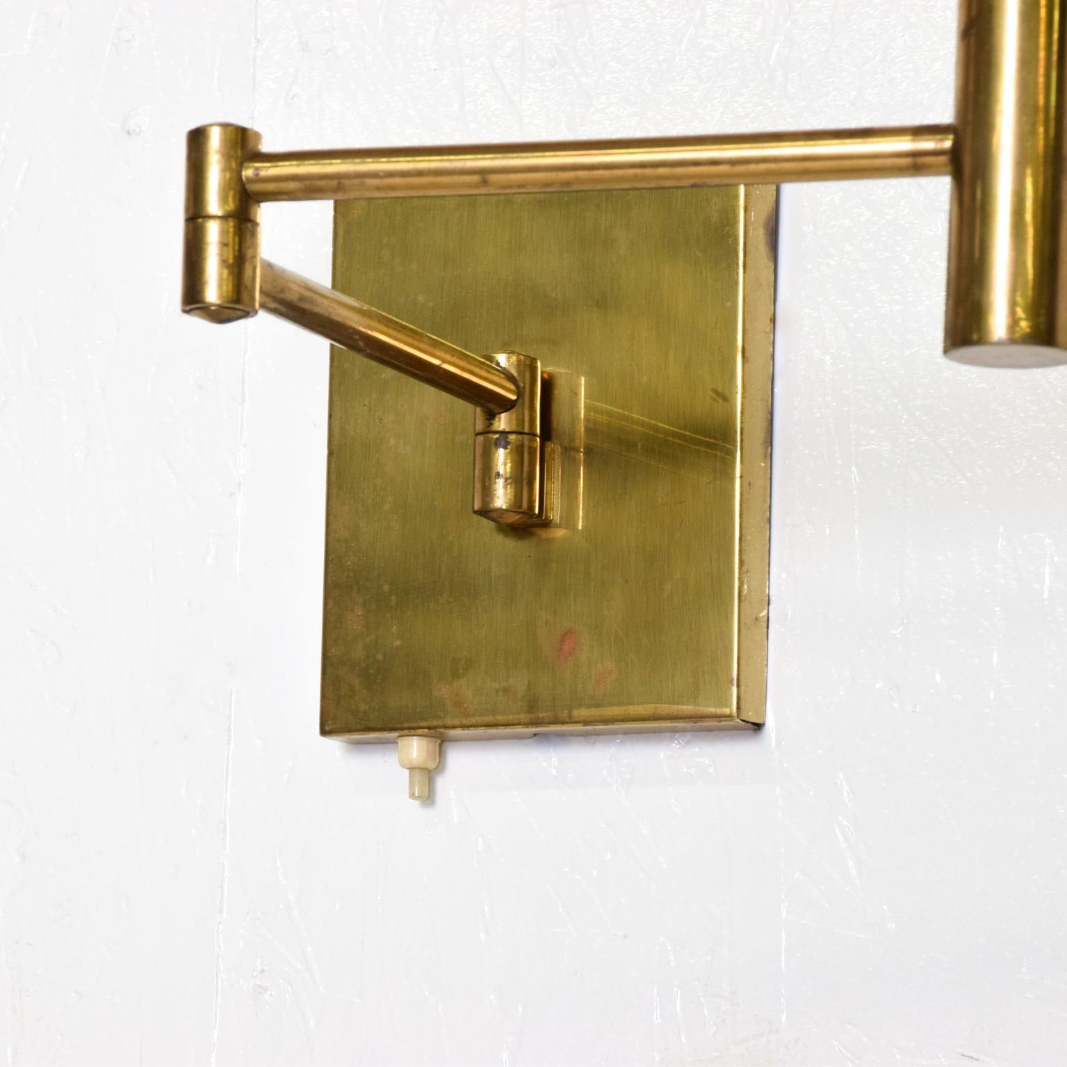 For your consideration, a pair of brass wall sconces, After Lightolier, Mid-Century Modern era. Articulated arm can be adjusted in almost any direction. No bulb or shades included. Dimensions: 17 1/2