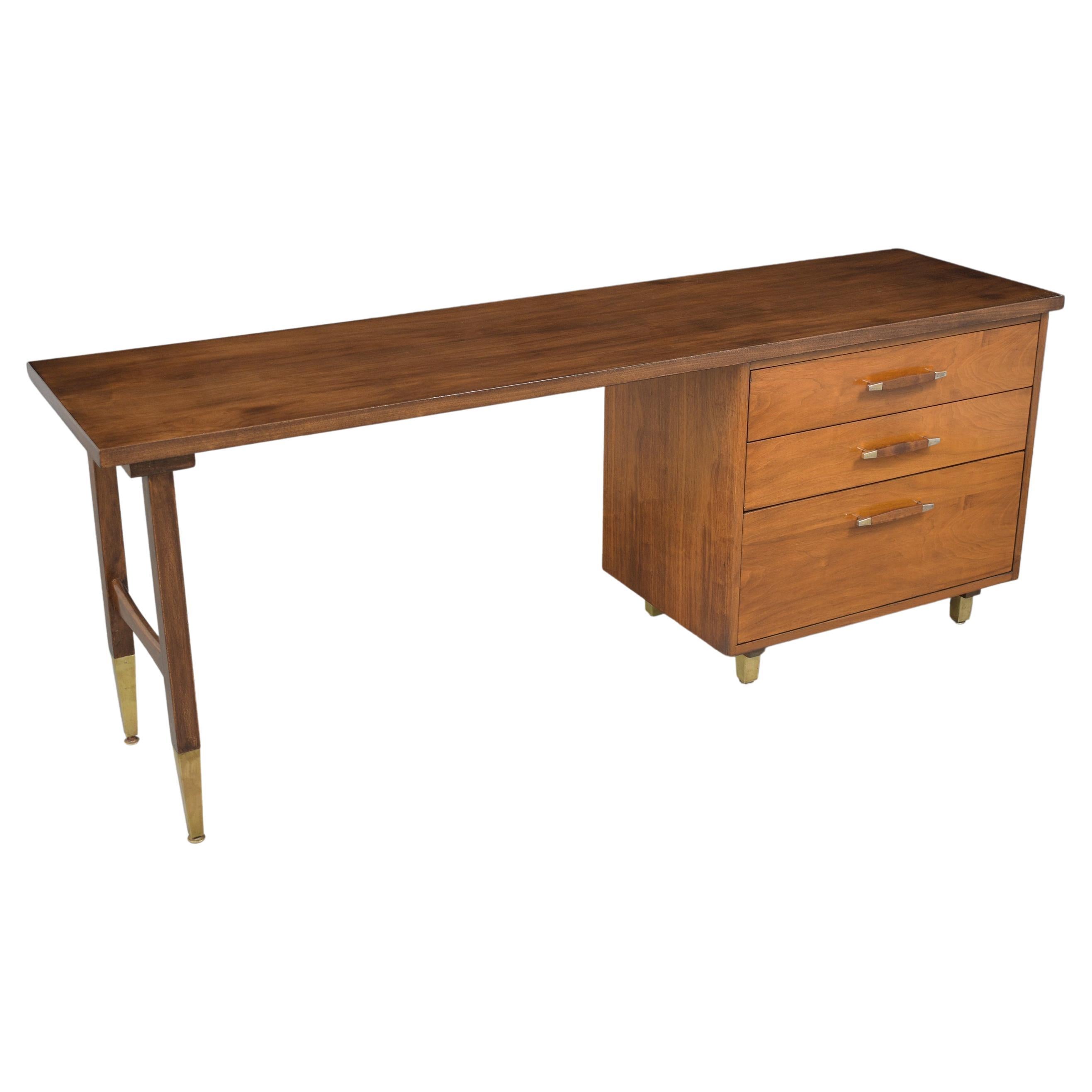 Experience the timeless elegance of our 1960s Mid-Century Modern Executive Desk, masterfully constructed from select walnut wood. This vintage writing table, restored to impeccable condition by our dedicated in-house craftsmen, is a testament to the