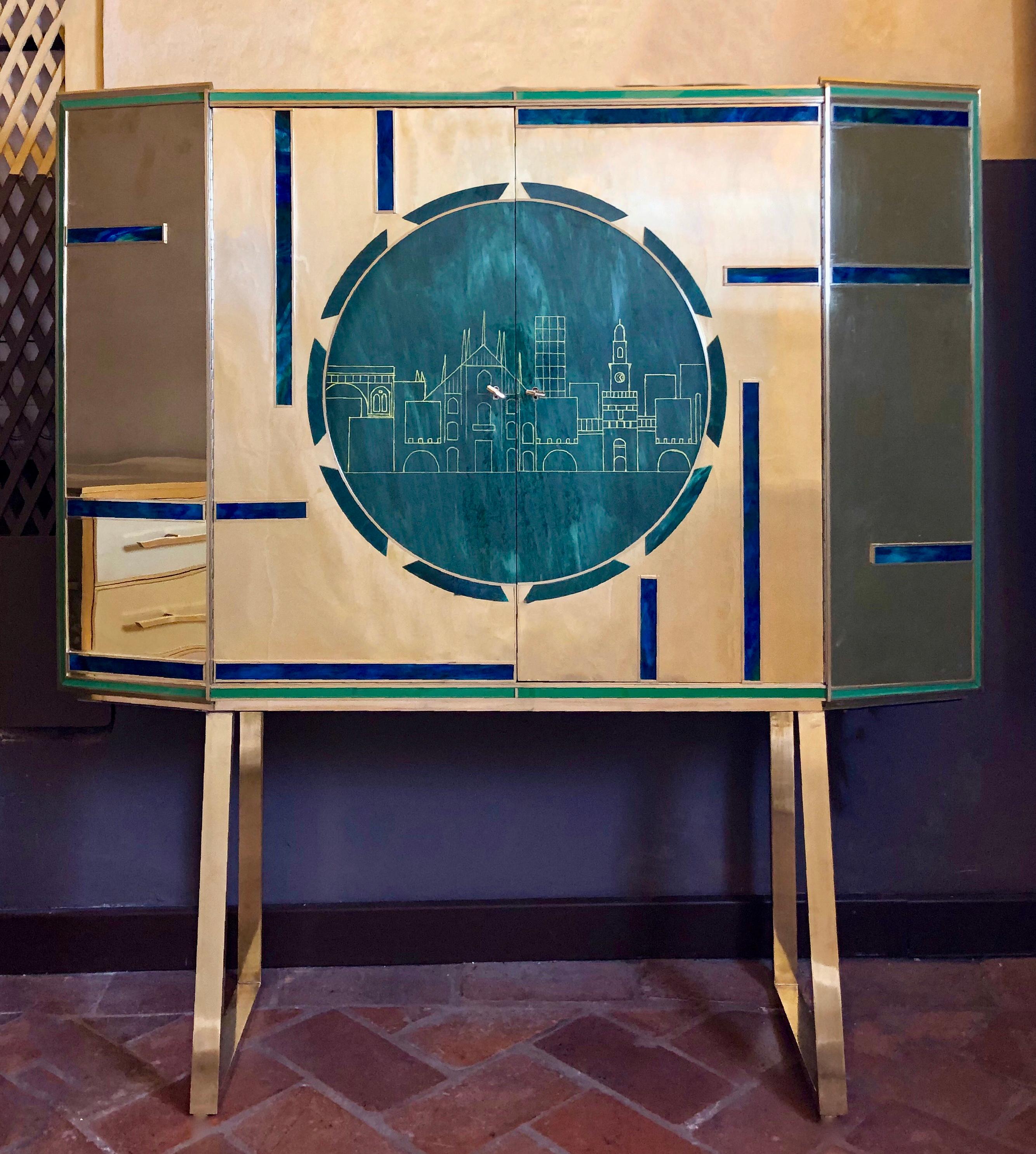 The wood and brass cabinet chassis has two hinged doors, one glass shelf in the middle and a mirror in the back of each side. The 57 cm. round Murano glass plate in the front of the dry bar has been engraved with an ideal sight view of a city