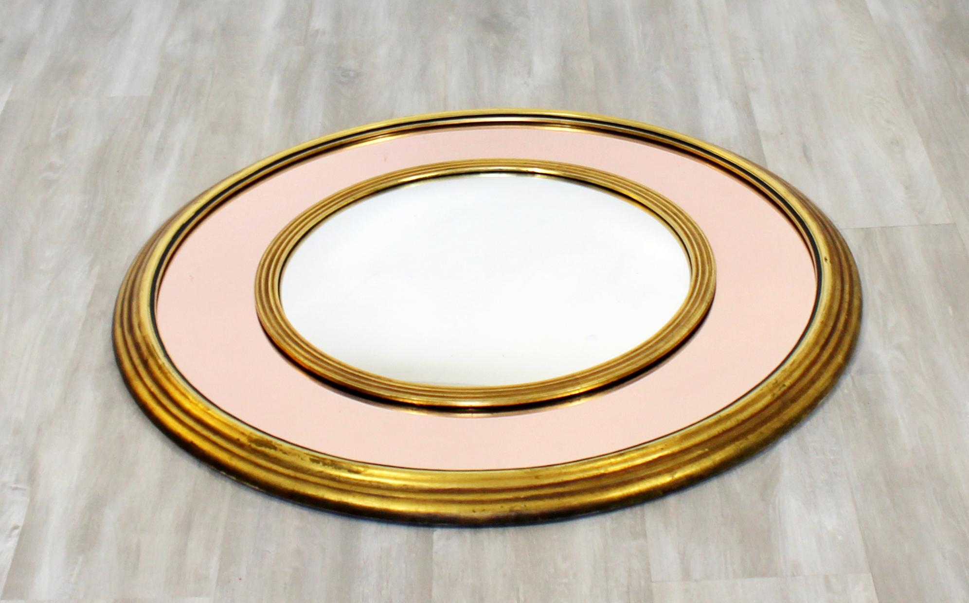 For your consideration is a fantastic, circular, convex wall mirror with brass and wood accents, the outer mirror has a rose gold tint, circa 1960s. In excellent condition. The dimensions are 13