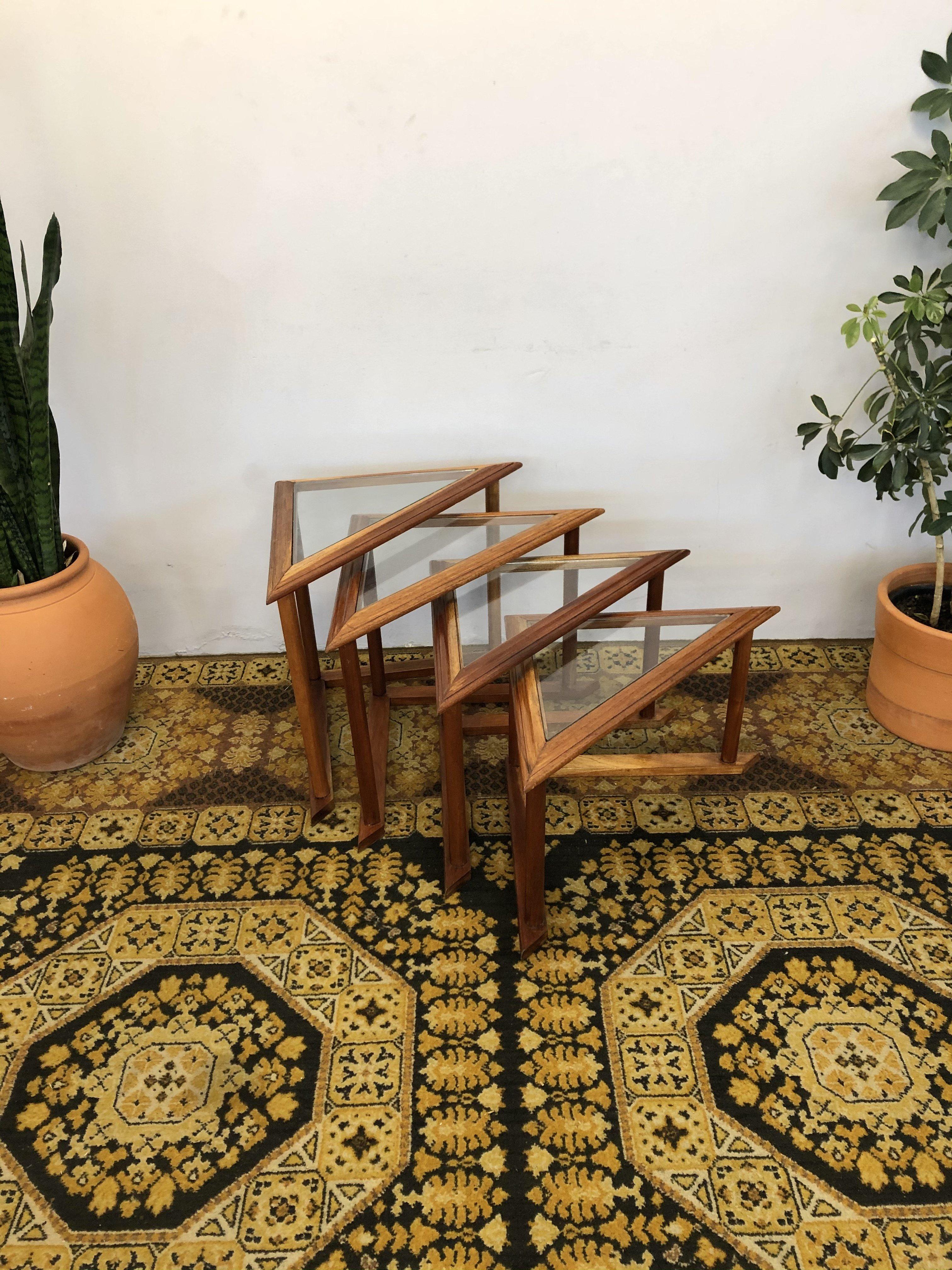 Set of 4 Mid-Century Modern Brazilian Nesting tables in solid wood (recently refinished) with glass top. Tops are removable. Wood has natural color variations. Firm and resistant structure. In great condition.

Approximate Measures from Largest to