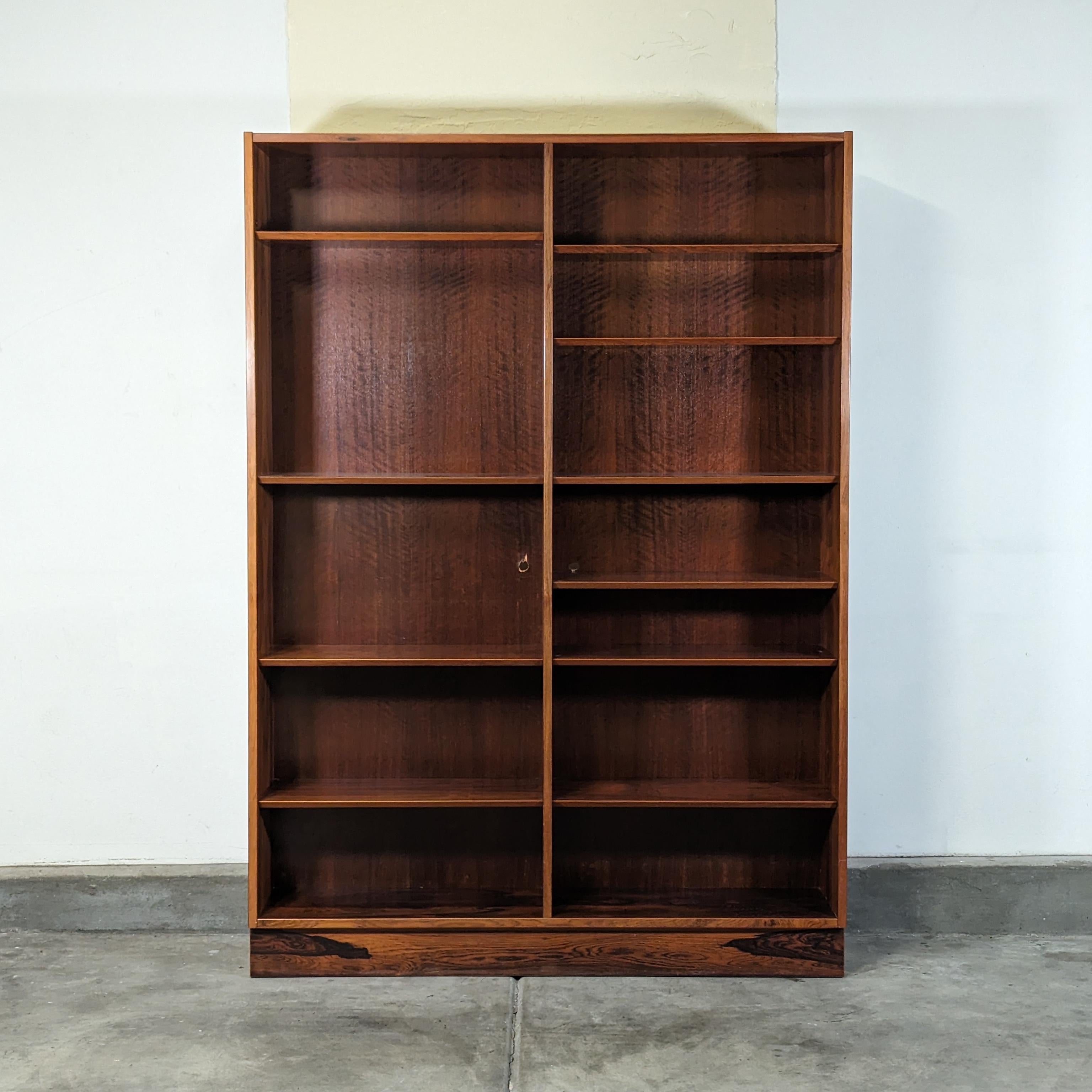 Step back in time with this exquisite vintage mid-century modern bookcase by Poul Hundevad, dating back to the 1960s, a true testament to timeless Scandinavian design. Crafted with an eye for detail, this piece showcases an extraordinary bookmatched