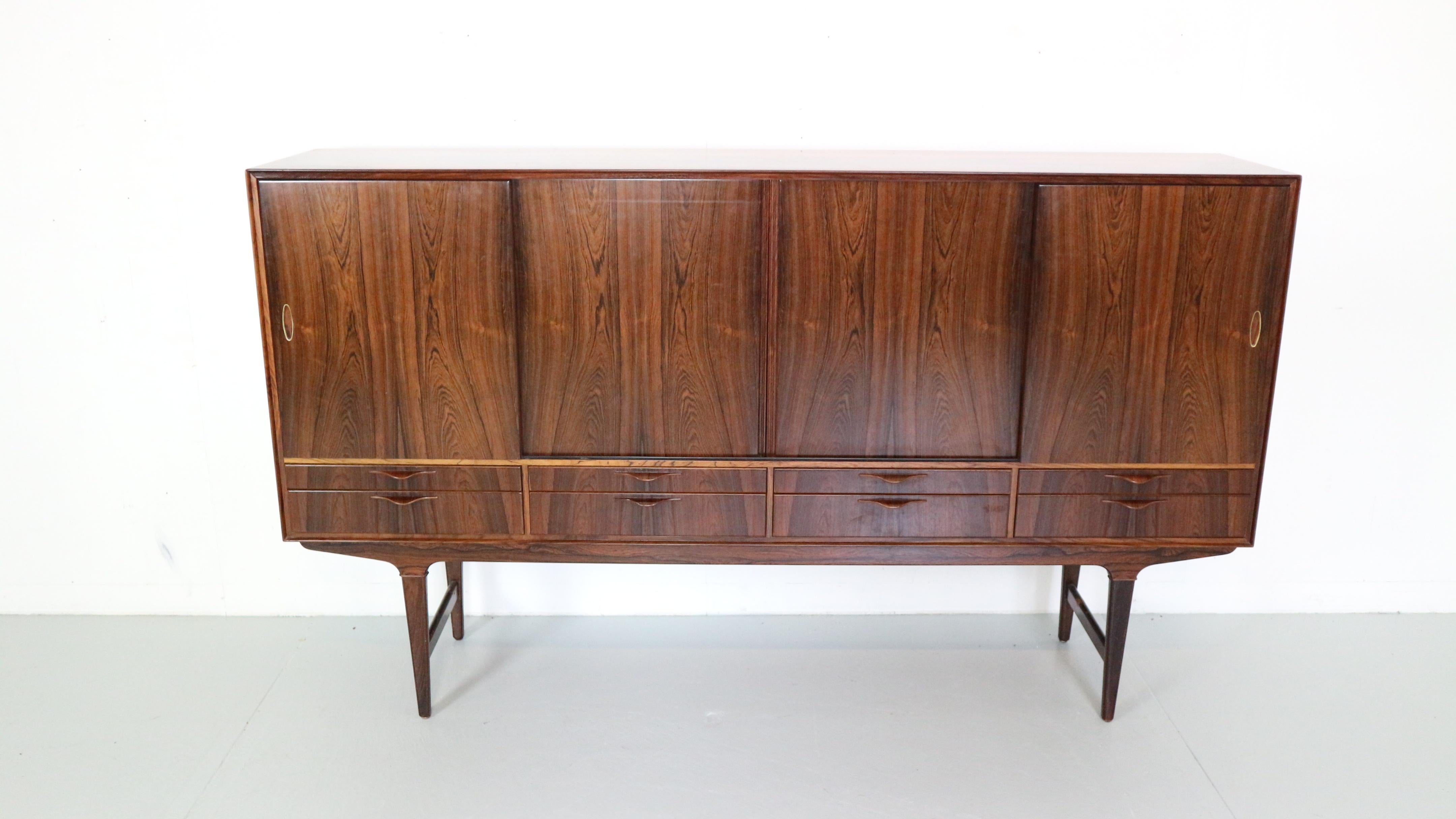Mid- Century modern credenza or in another words highborn cabinet made in 1960's period, Denmark.

The cabinet is in a great vintage condition.
Made of Brazilian rosewood and has a beautiful tiger wooden patina.
Plenty of storage space.


Due to