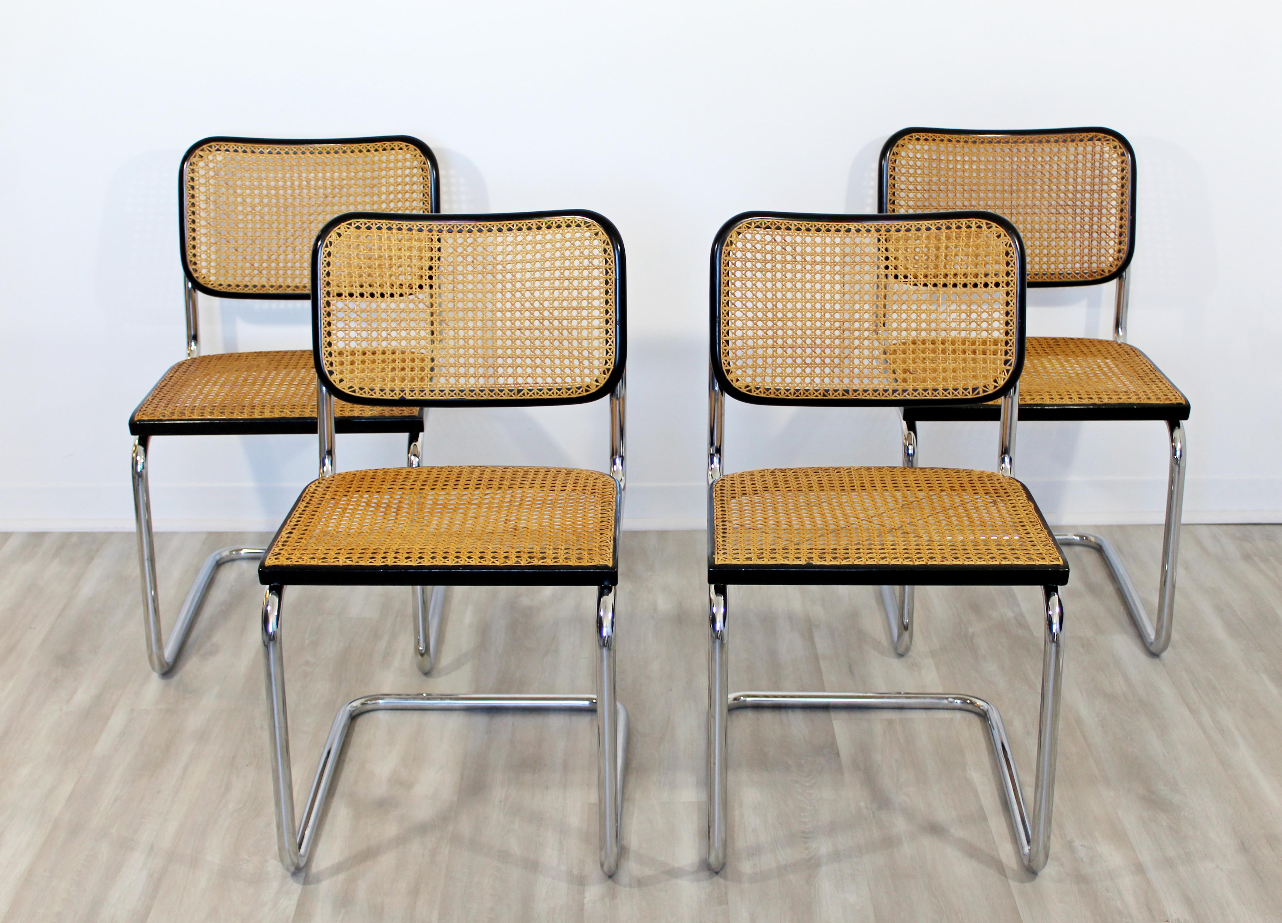 For your consideration is a gorgeous set of four side dining chairs, made of cantilevered chrome and black lacquered wood, with cane, by Marcel Breuer for Knoll, circa 1970s. In excellent vintage condition. The dimensions are 18