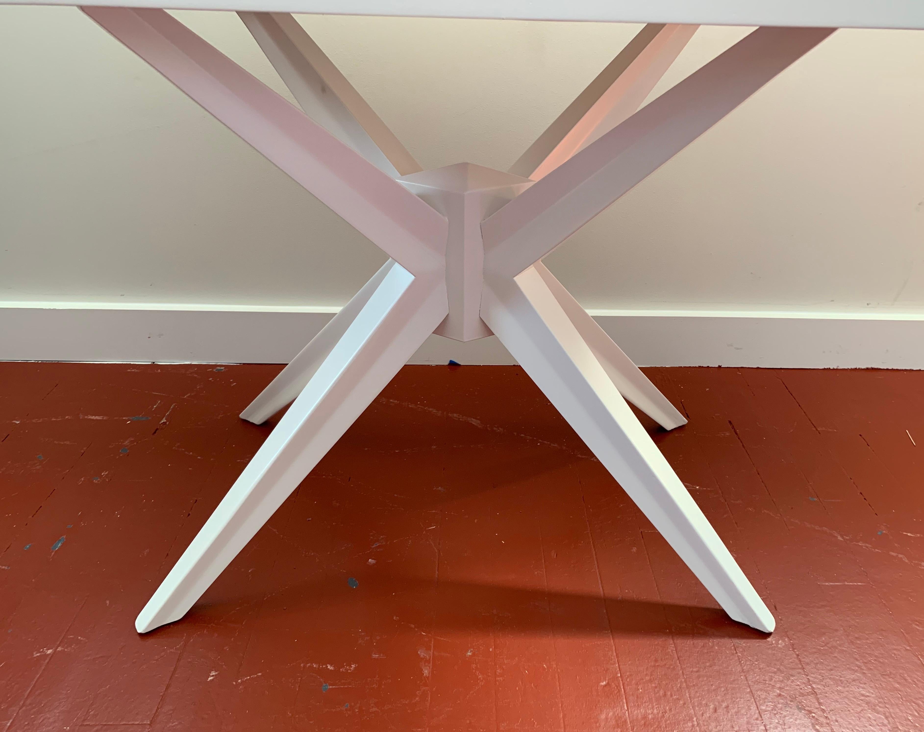 Iconic Mid-Century Modern newly refurbished white lacquer table. The color is brilliant white lacquer,
circa 1960s. Features single drawer and atomic legs.