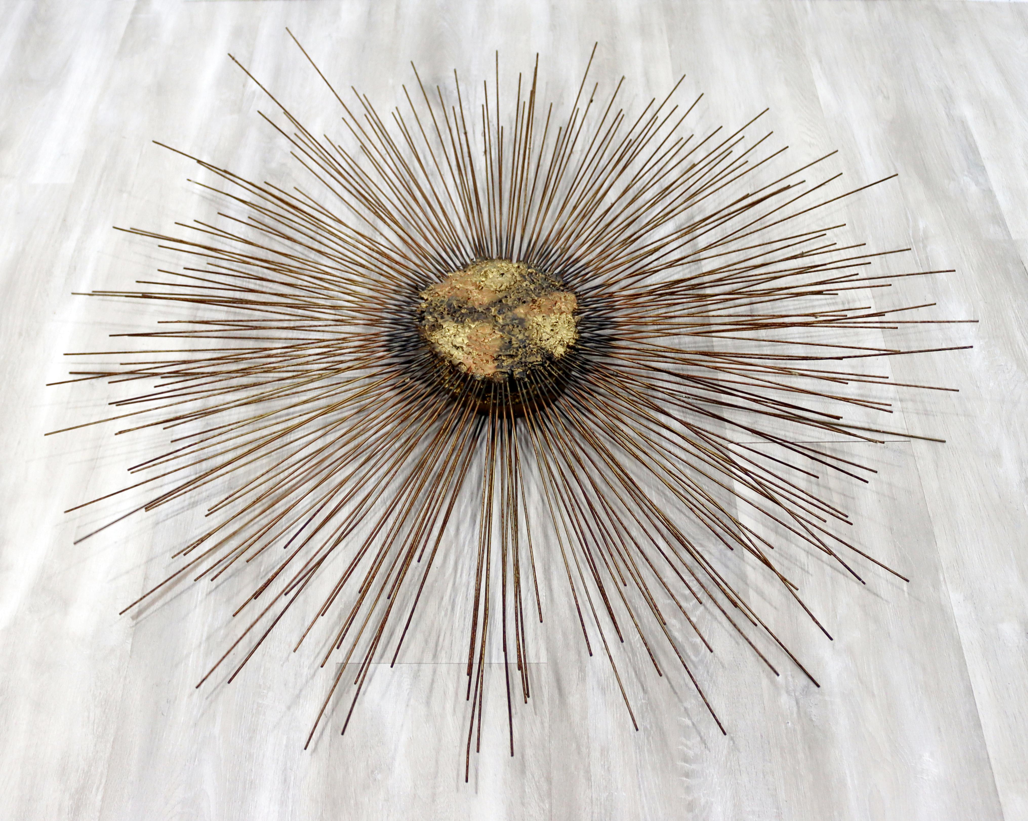 For your consideration is a beautiful, Brutalist, bronze wall sculpture, of a sunburst, circa the 1970s. In excellent condition. The dimensions are 37