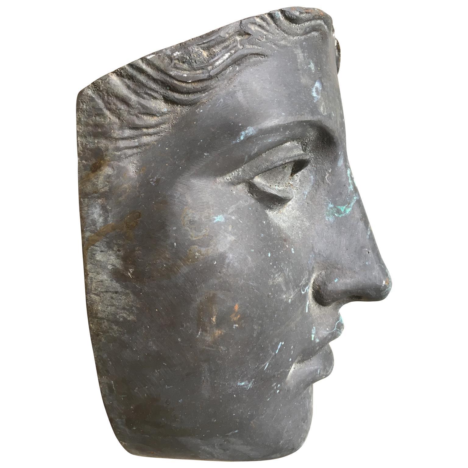 Mid-Century Modern bronze face mask of a woman with its original outdoor patina.