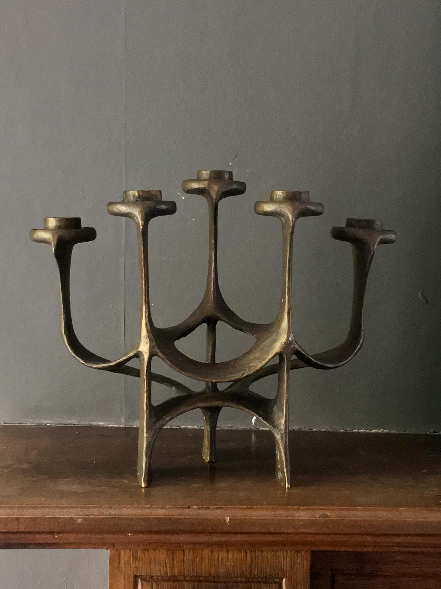 Brutalist bronze candlestick or candelabra with five vertical arms at three different heights. European, mid-20th century - circa 1960s or 1970s.

A heavy piece, made of cast bronze, with a very dark brown patina, which shows softer tones (red to