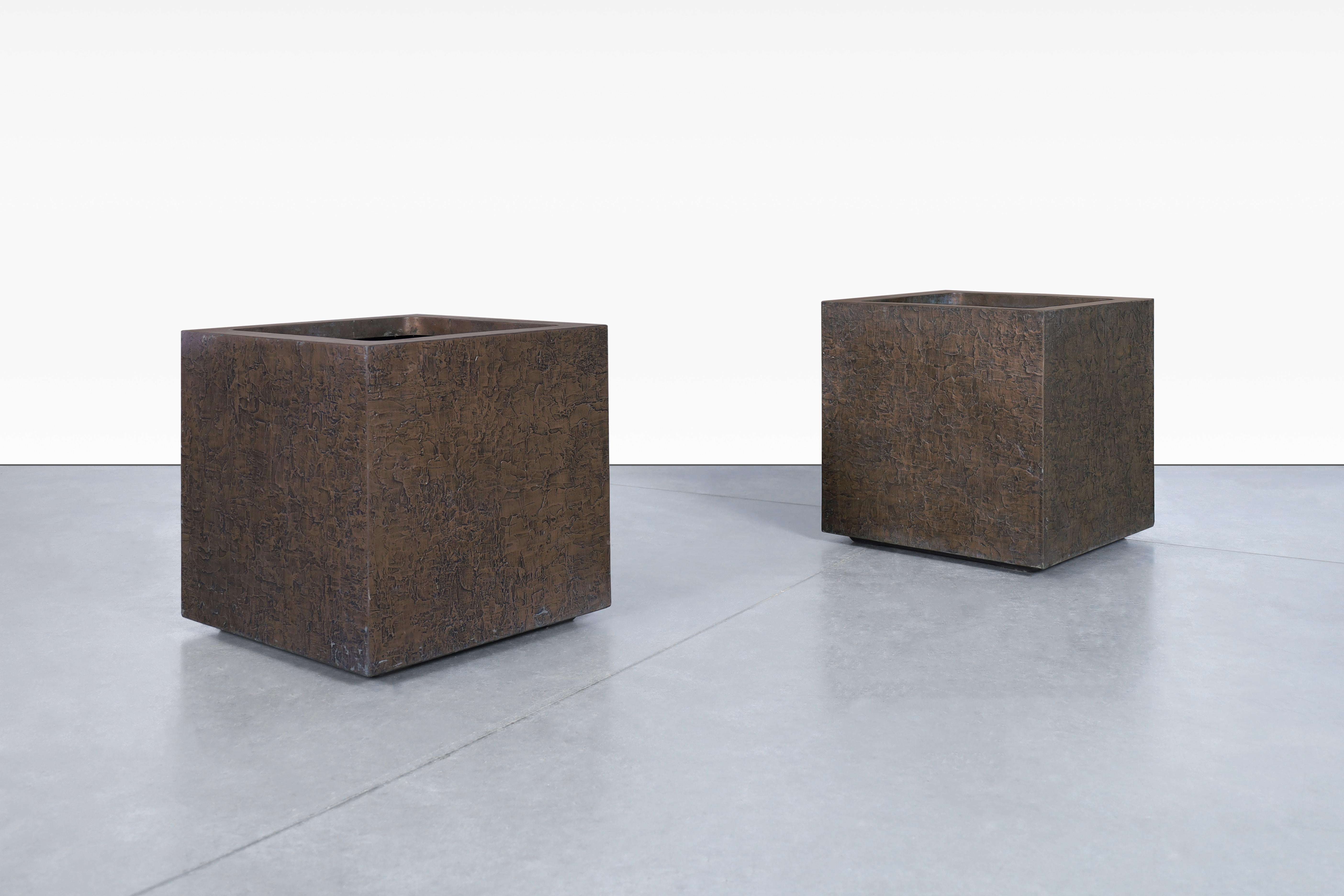 Beautiful mid-century modern bronze resin square planters manufactured in the United States, circa 1970s. These planters are manufactured by the well-known company Forms and Surfaces, and showcase a harmonious fusion of bronze resin, fiberglass, and