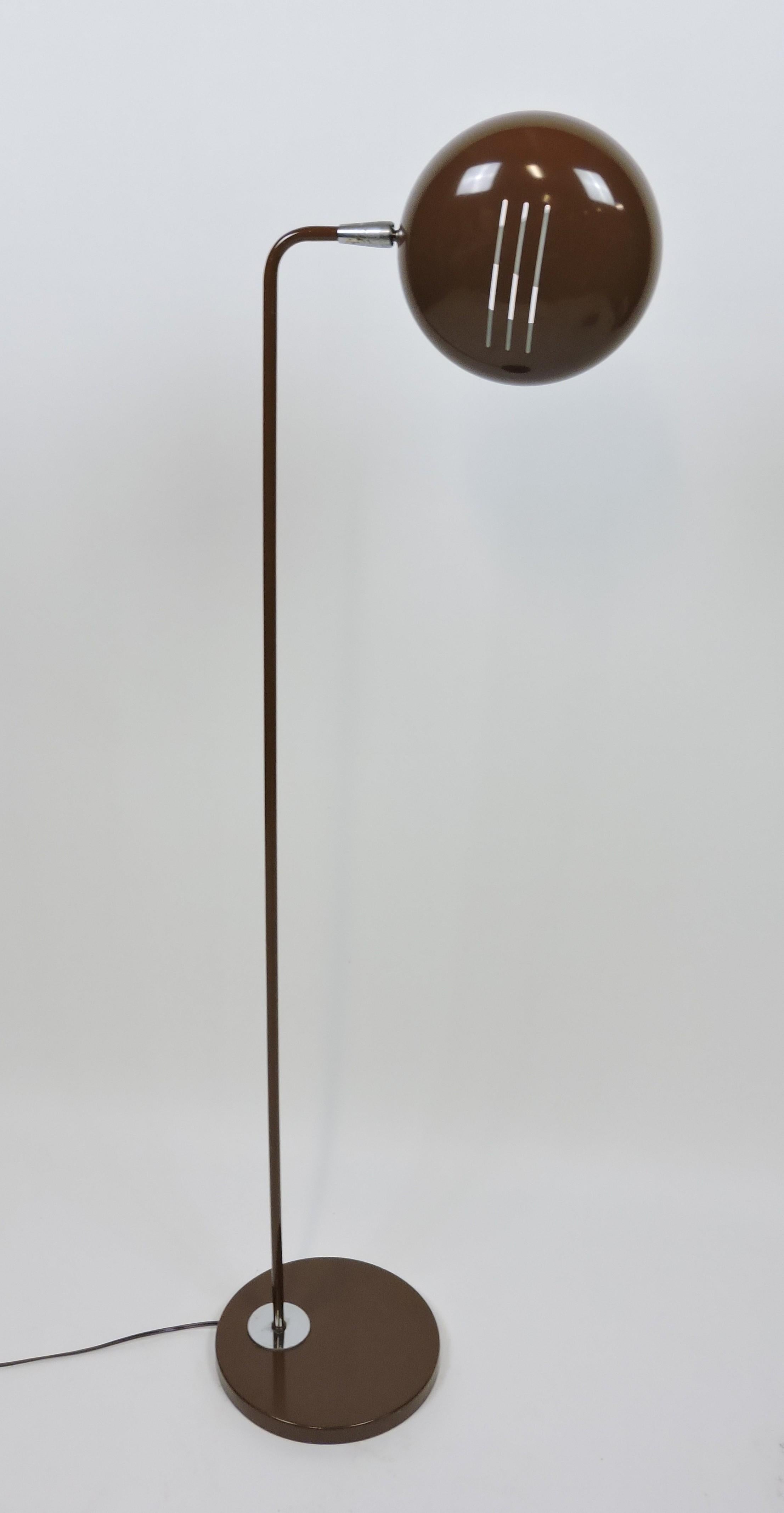 Very cool mid century floor lamp with a brown enamel finish and an articulated shade. This heavy and well-made lamp has a round shade that can be adjusted to any angle and takes a single standard base bulb. It has all new wiring.
