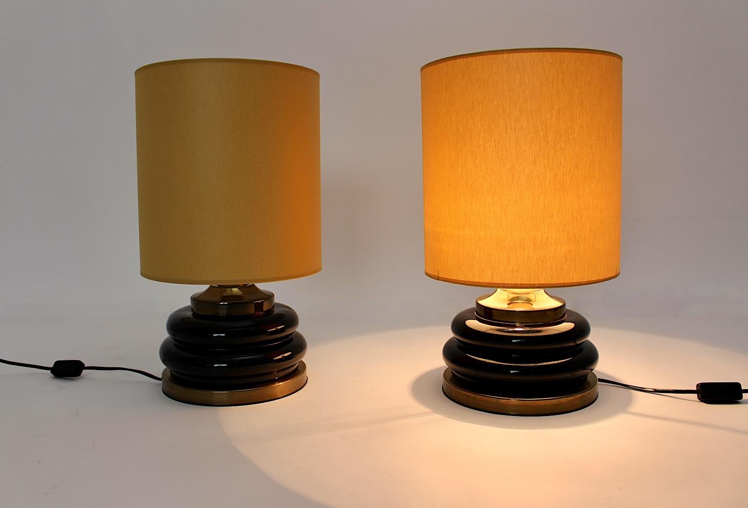 Modernist vintage table lamps duo pair from brown and gold glass, which was designed and manufactured Italy, 1970s.
An amazing pair of table lamps with rounded edges at the glass base with brass and plastic details give the pair of table lamps a