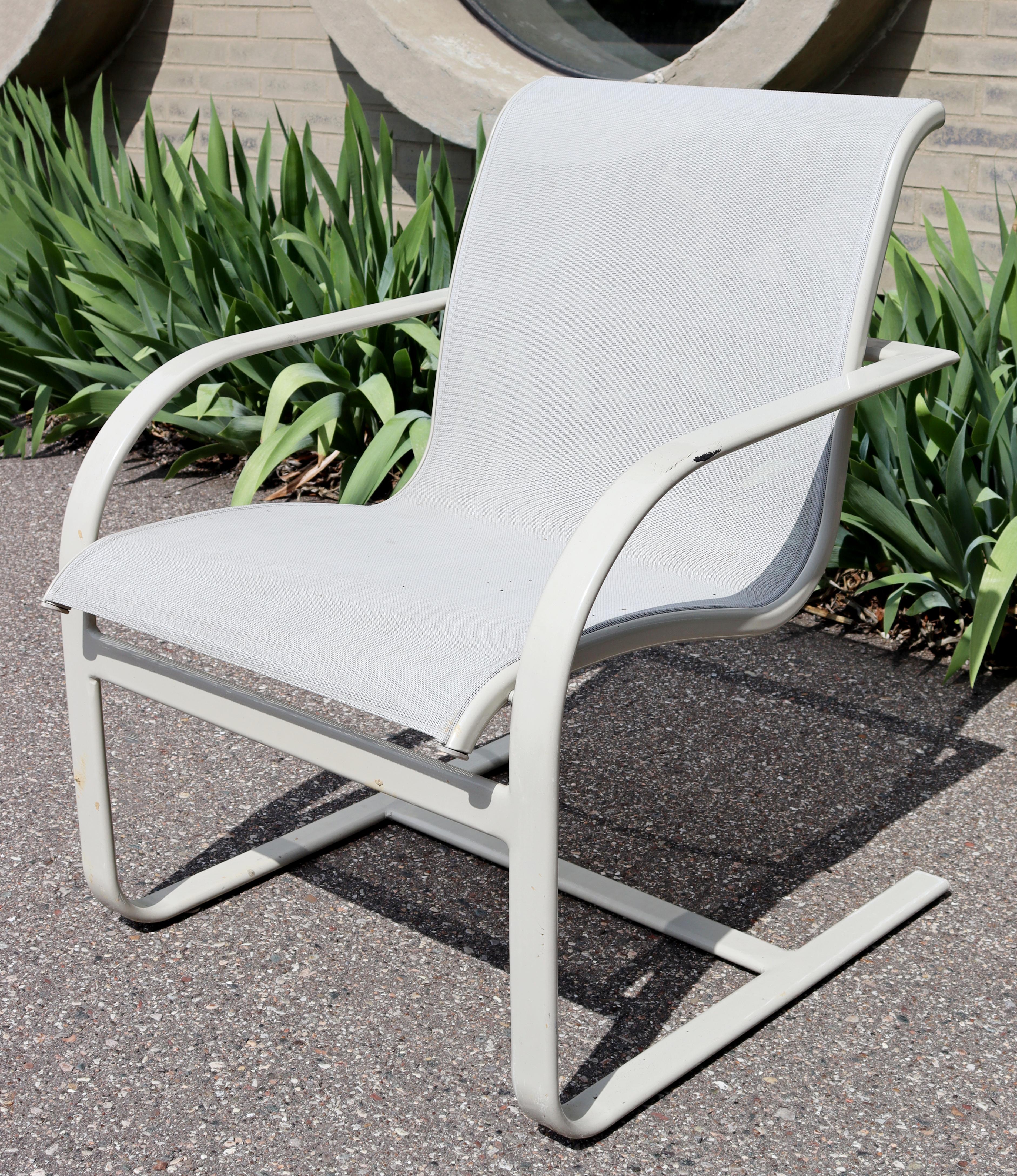 For your consideration is an incredible, outdoor patio set of four rocking armchairs, made of white painted metal and with mesh backs and seats, by Brown Jordan, circa the 1970s. In very good vintage condition. The dimensions are 24.5