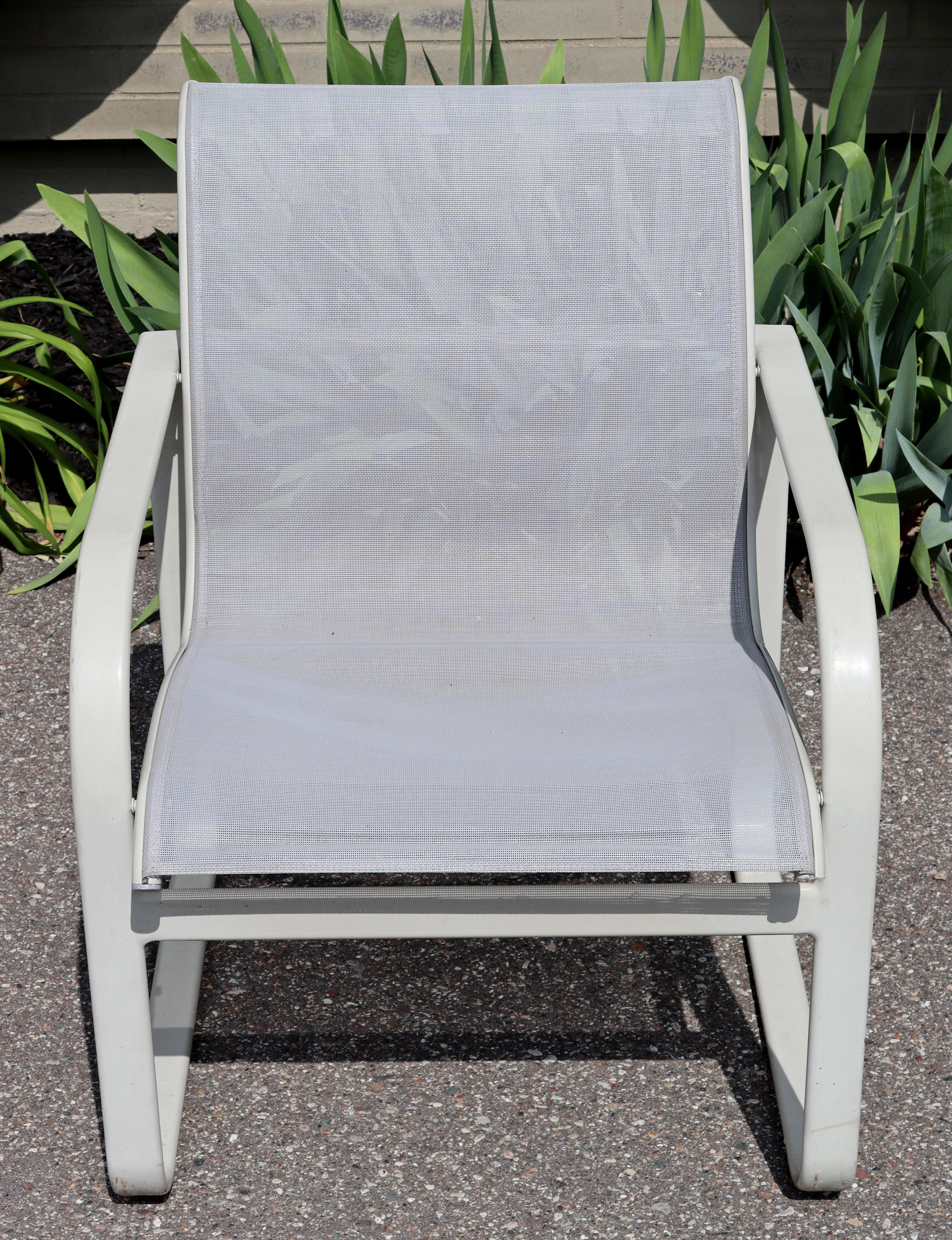 For your consideration is a superb, outdoor patio set of eight armchairs, made of Off white painted metal and with light gray mesh backs and seats, by Brown Jordan, circa the 1970s. In very good vintage condition. The dimensions are 24.5