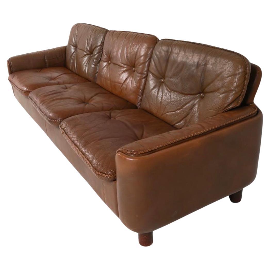 Mid century Scandinavian modern brown leather 3 seat sofa round legs. Beautiful brown soft leather is soft and shows signs of use and fading/patina but broken in nicely. Great small Danish Modern sofa with leather woven cushions. Good vintage