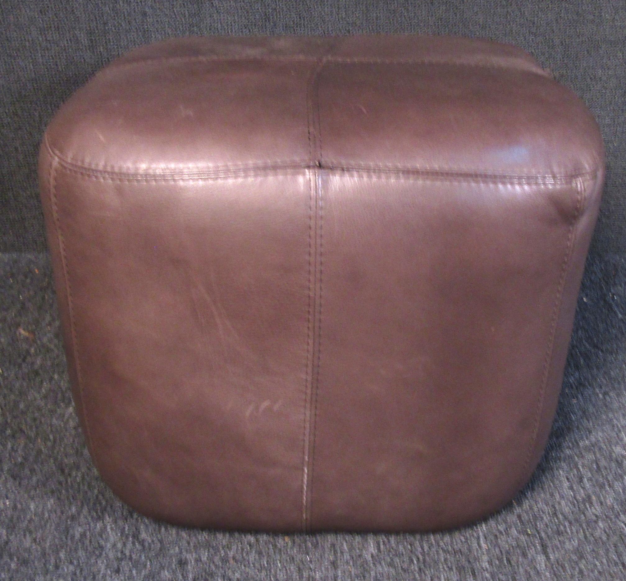 Plush vintage modern ottoman upholstered in a rich brown leather. Versatile size and shape allows it to be used traditionally as an ottoman, as a side chair, or even as a coffee table.

Please confirm item location (NY or NJ).