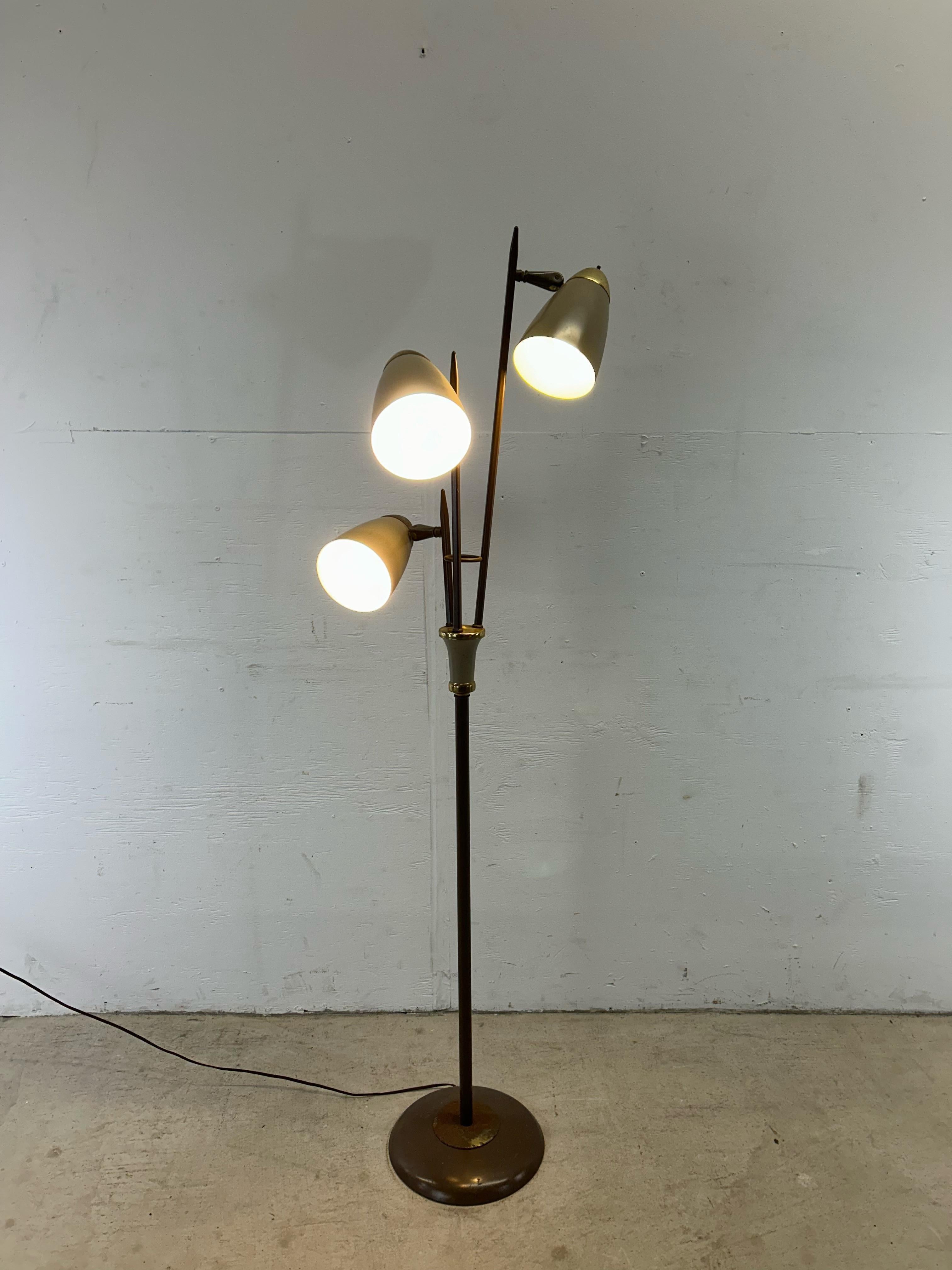 This mid century modern floor lamp features brown painted metal base with three brass accented bullet shades.  Each bulb can be controlled separately with its own switch.

Base measures: 11w 11d 

Dimensions: 21w 21d 61h

Condition: Metal base and
