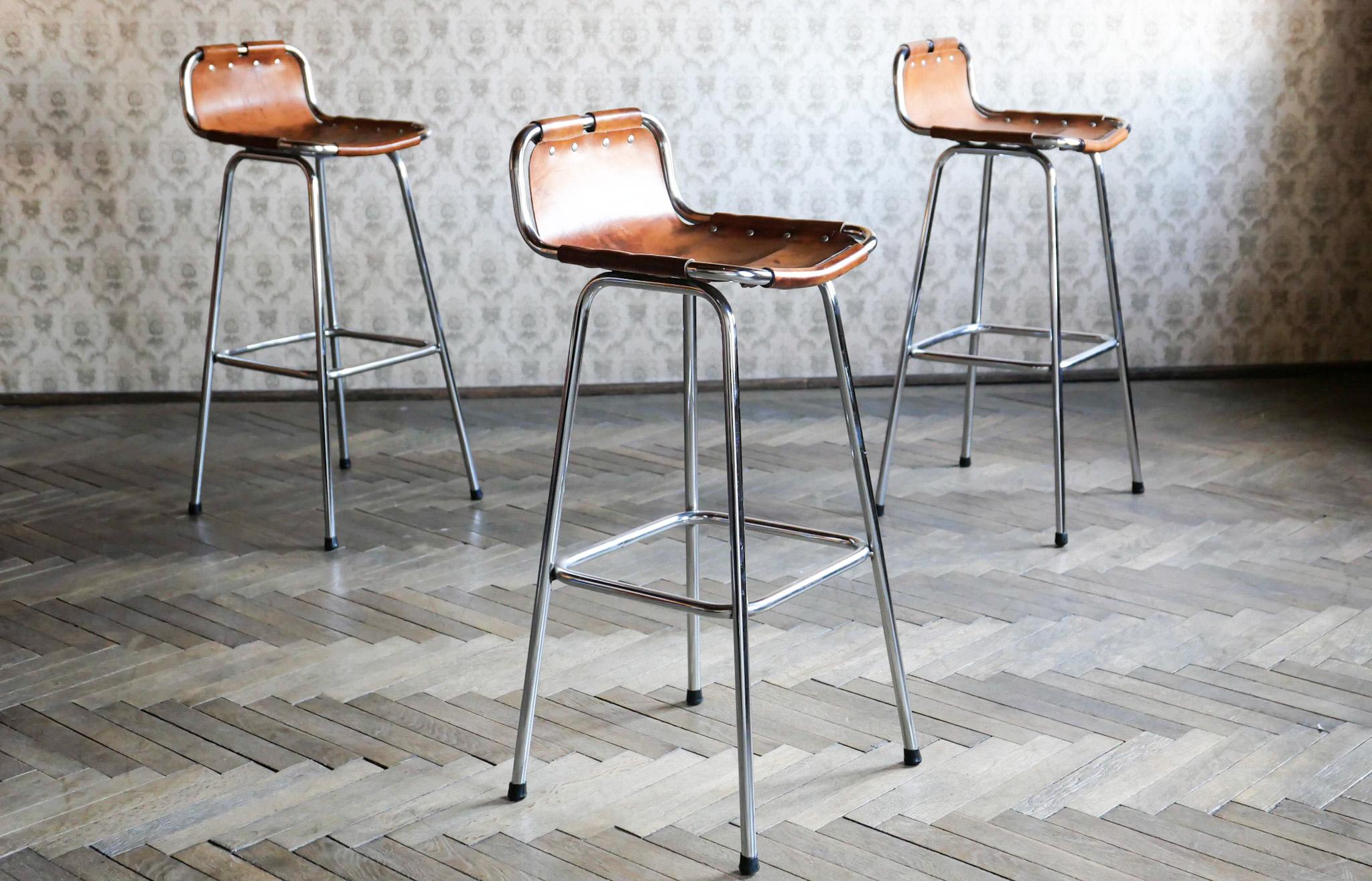 Mid-Century Modern brown saddle leather bar stools, Charlotte Perriand, France 1960s.

Stunning set of 3 French Mid-Century Modern bar stools designed by Charlotte Perriand for the ski resort “Les Arcs” in France 1960. The stools have chrome plated