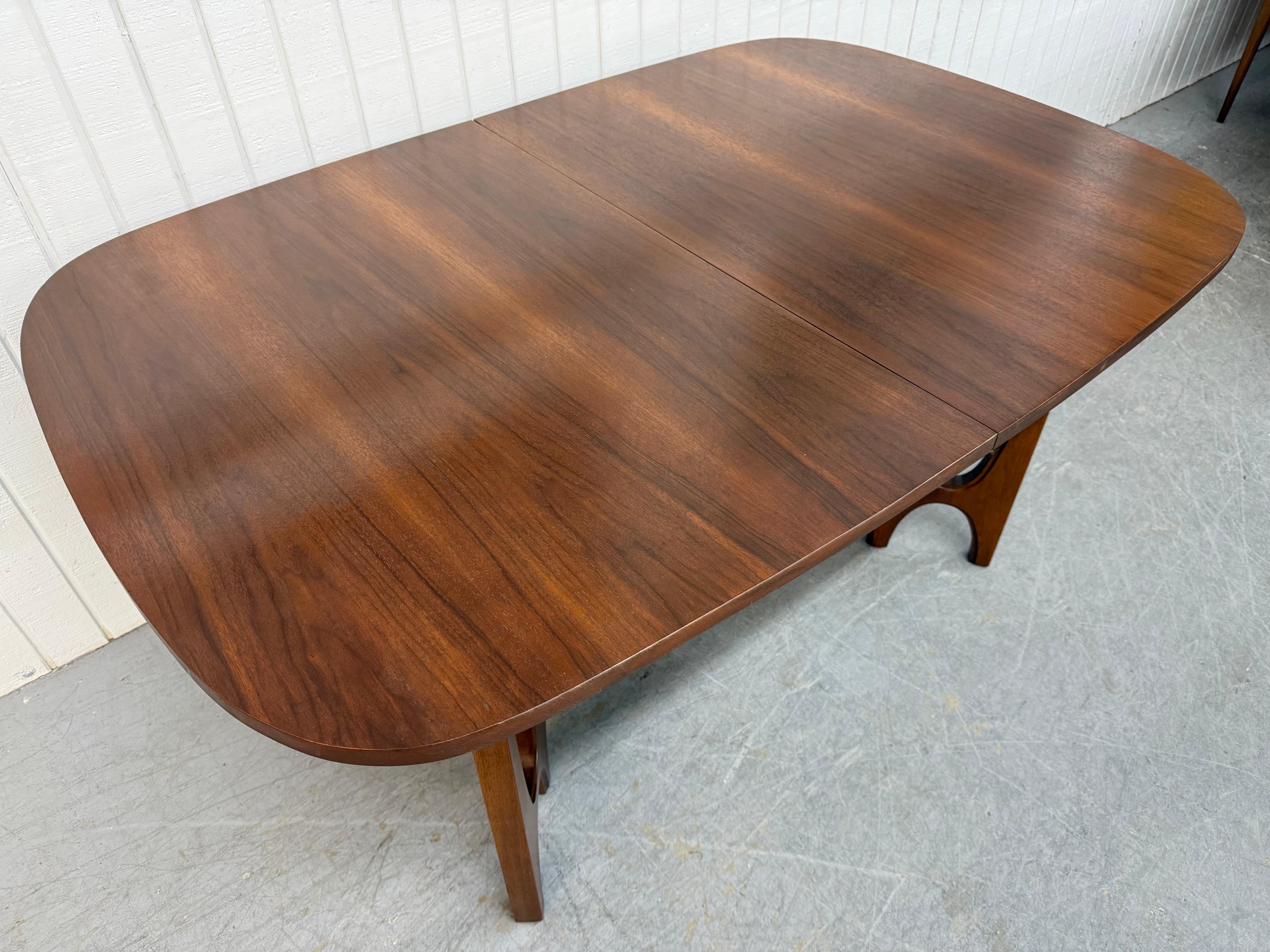 This listing is for a Mid-Century Modern Broyhill Brasilia 2 Walnut Dining Table. Featuring an oval top, sculpted pedestal base legs, and a beautiful walnut finish. This is an exceptional combination of quality and design by Broyhill!