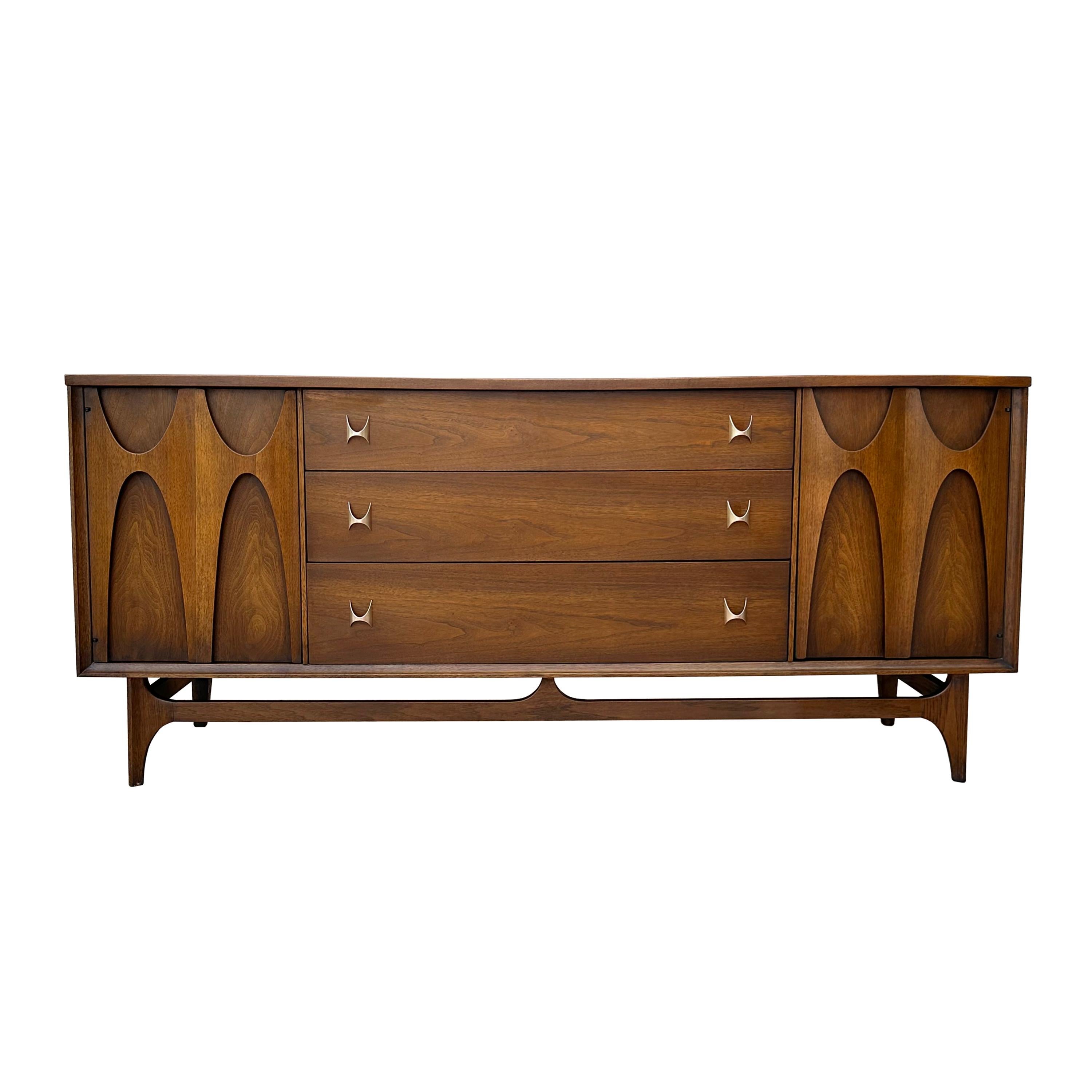 1960s Mid-Century Modern Brasilia walnut bedroom set by Broyhill. This set features 2 nightstands, a long dresser and a gentleman's chest. Good vintage condition with some wear. This set is sleek and modern and would be a great addition to any
