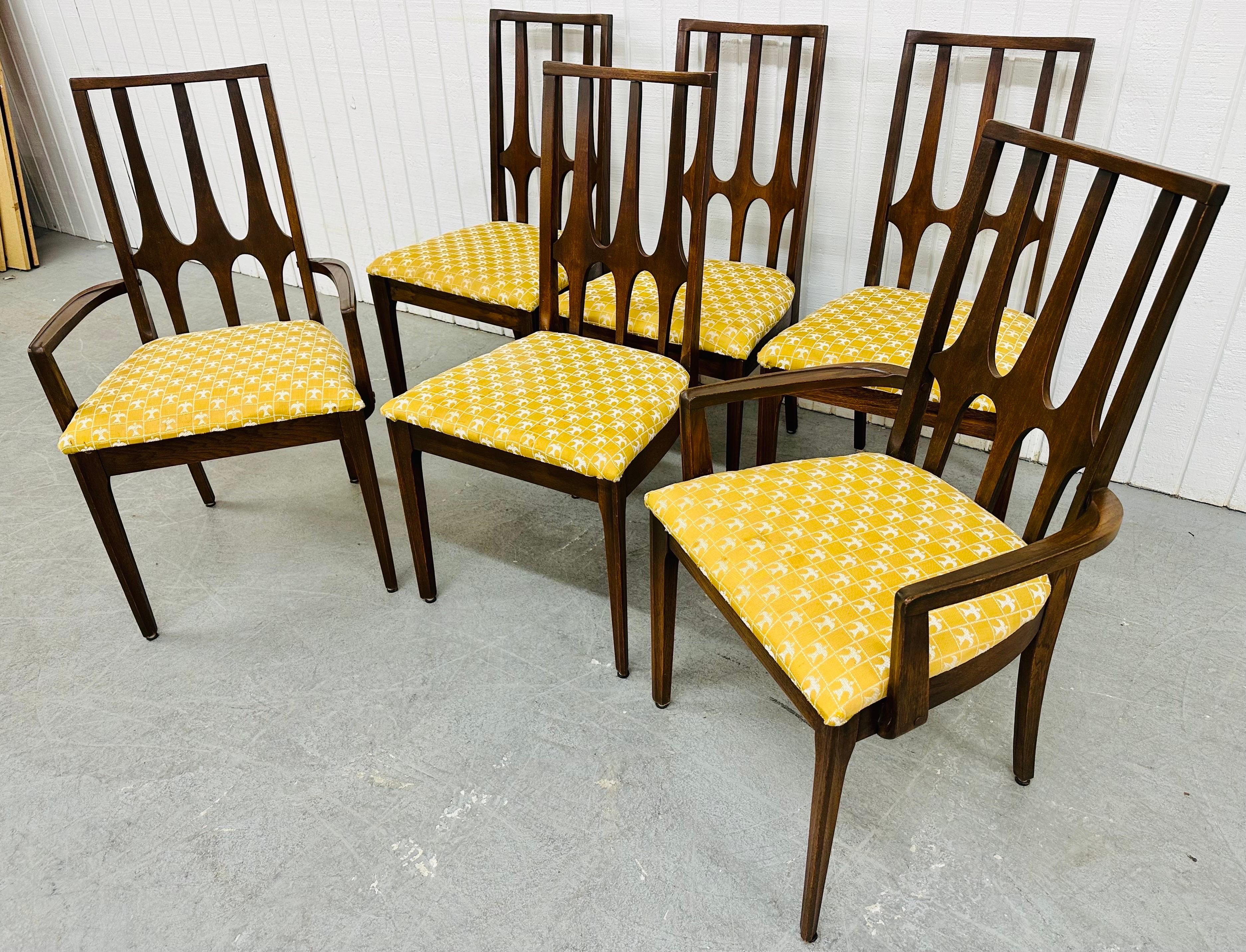 This listing is for a set of six Mid-Century Modern Broyhill Brasilia Walnut Dining Chairs. Featuring two arm chairs, four side chairs, sculpted Brasilia high back rests, modern legs, and original gold Brasilia upholstered seats. This is an