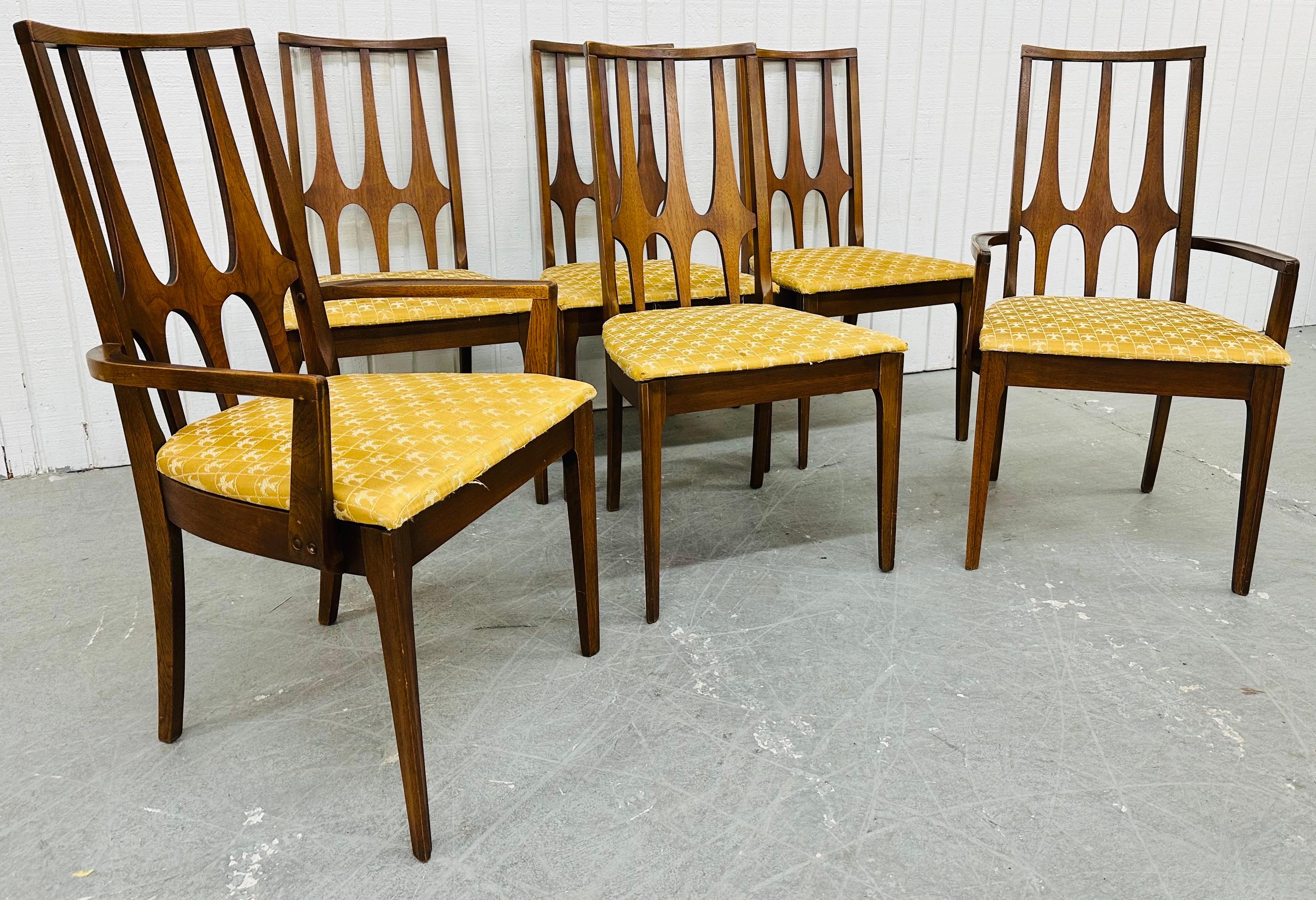 This listing is for a set of six Mid-Century Modern Broyhill Brasilia Walnut Dining Chairs. Featuring a high back sculpted design, two arm chairs, four side chairs, original Brasilia golden upholstery, modern legs, and a walnut finish. This is an