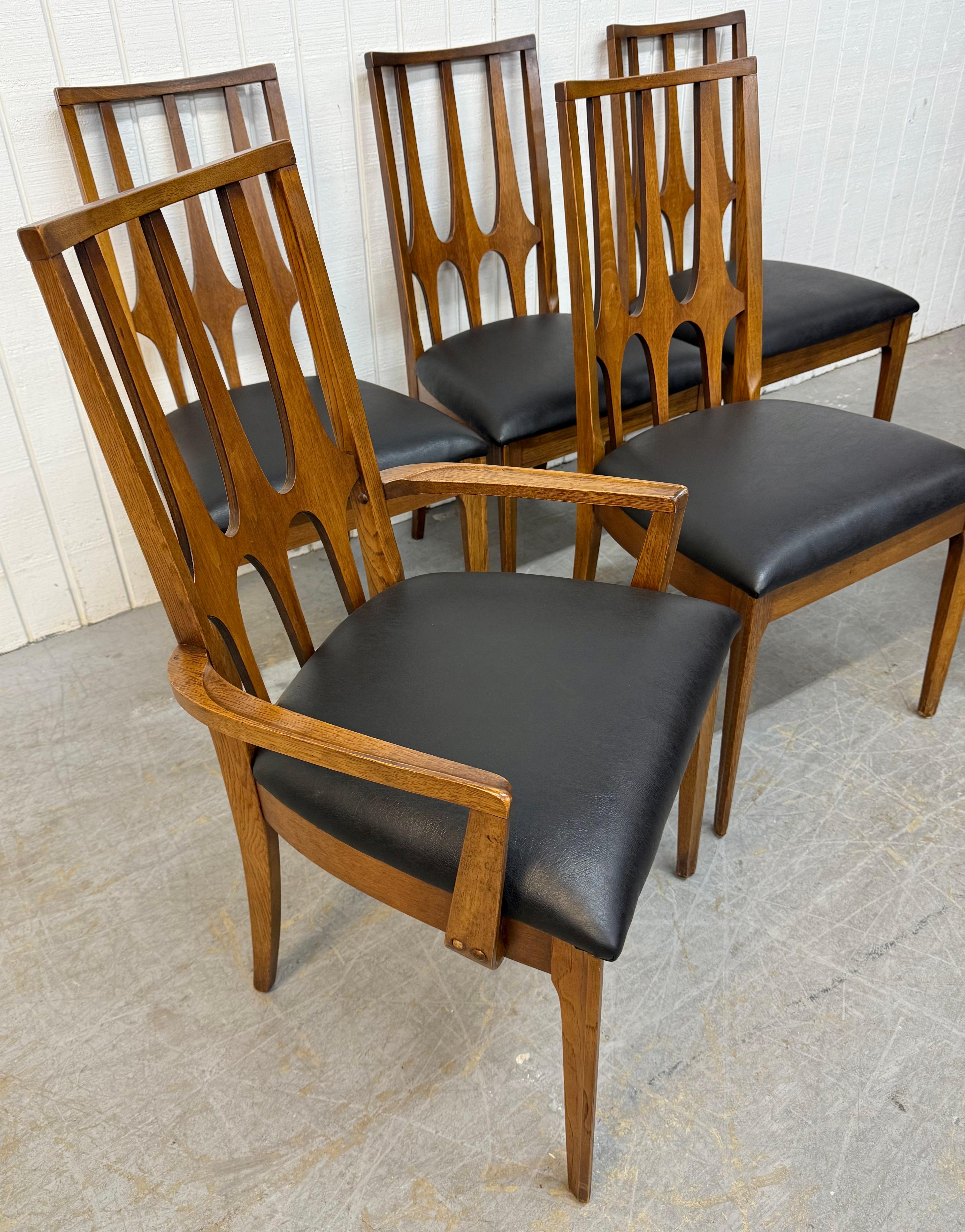 This listing is for a set of Mid-Century Modern Broyhill Brasilia Walnut Dining Chairs. Featuring a high back sculpted arch design, two arm chairs, four side chairs, original walnut finish, modern legs, and new black vinyl upholstered seats. This is