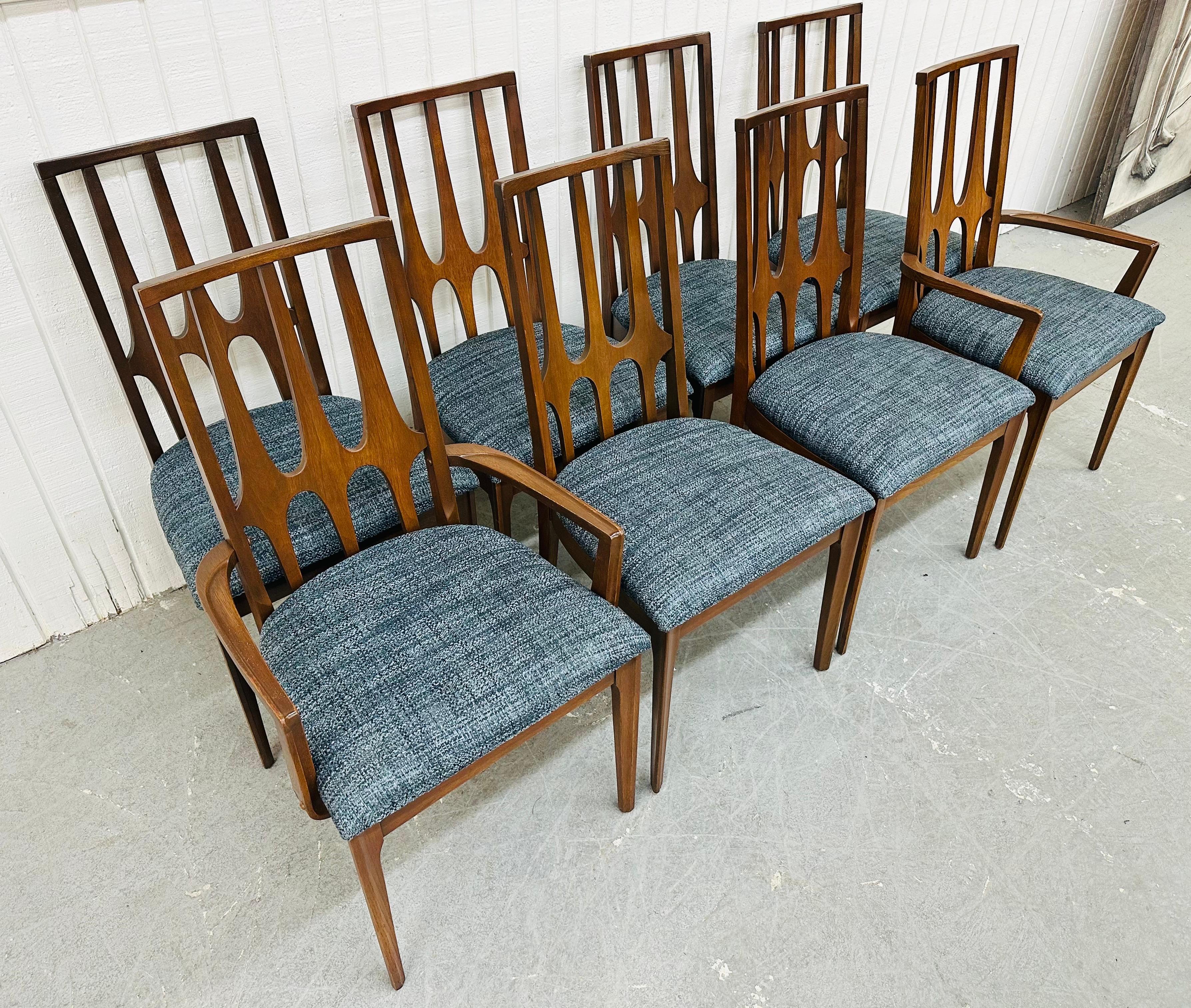 This listing is for a set of eight Mid-Century Modern Broyhill Brasilia Walnut Dining Chairs. Featuring a sculpted high back design, two arm chairs, six side chairs, newly upholstered blue seats, modern legs, and a beautiful walnut finish. This is