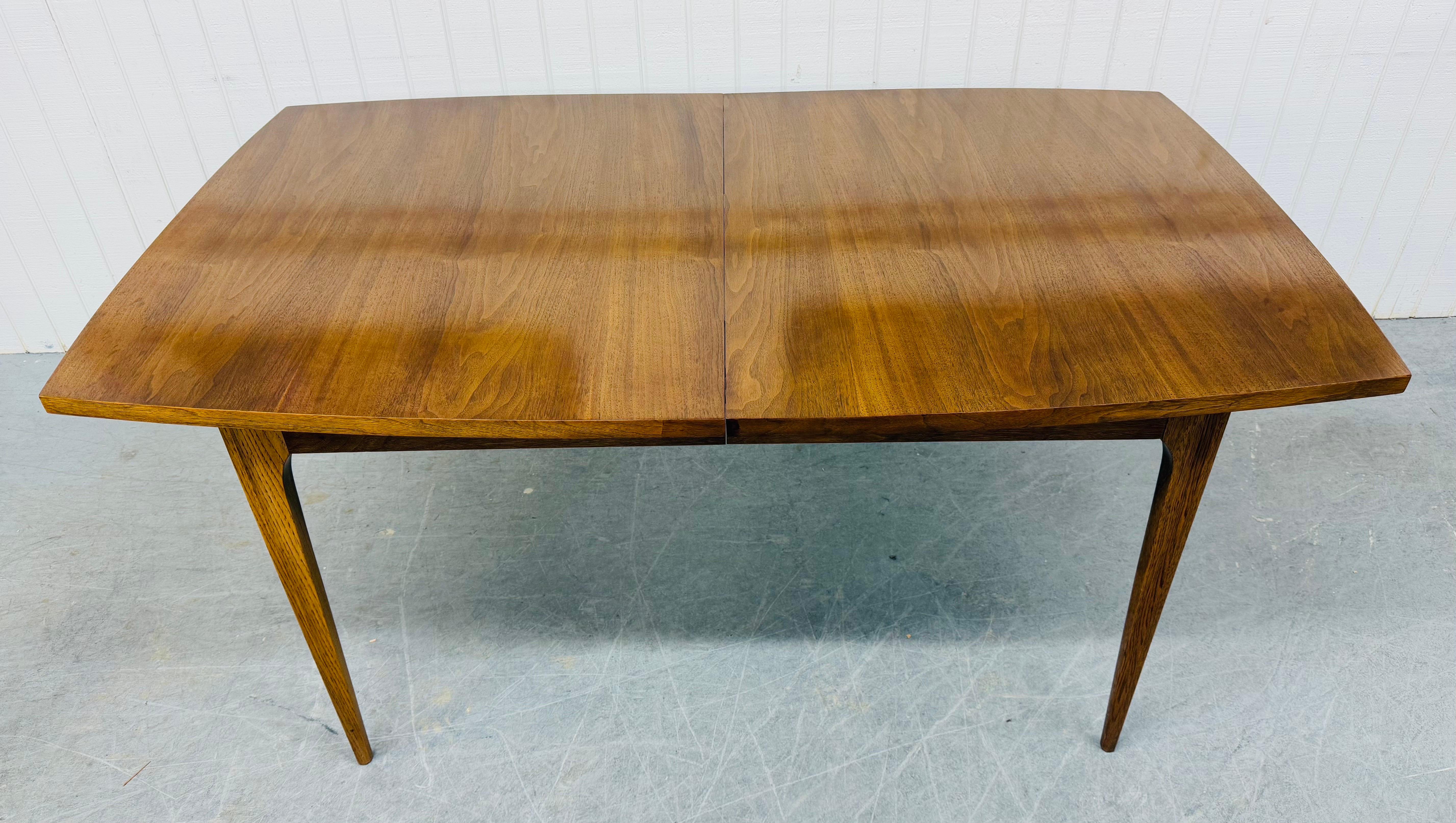 This listing is for a Mid-Century Modern Broyhill Brasilia Walnut Dining Table. Featuring a rectangular top, one leaf that extends the table to 78” L, four pinched removable modern legs, and a beautiful walnut finish. This is an exceptional
