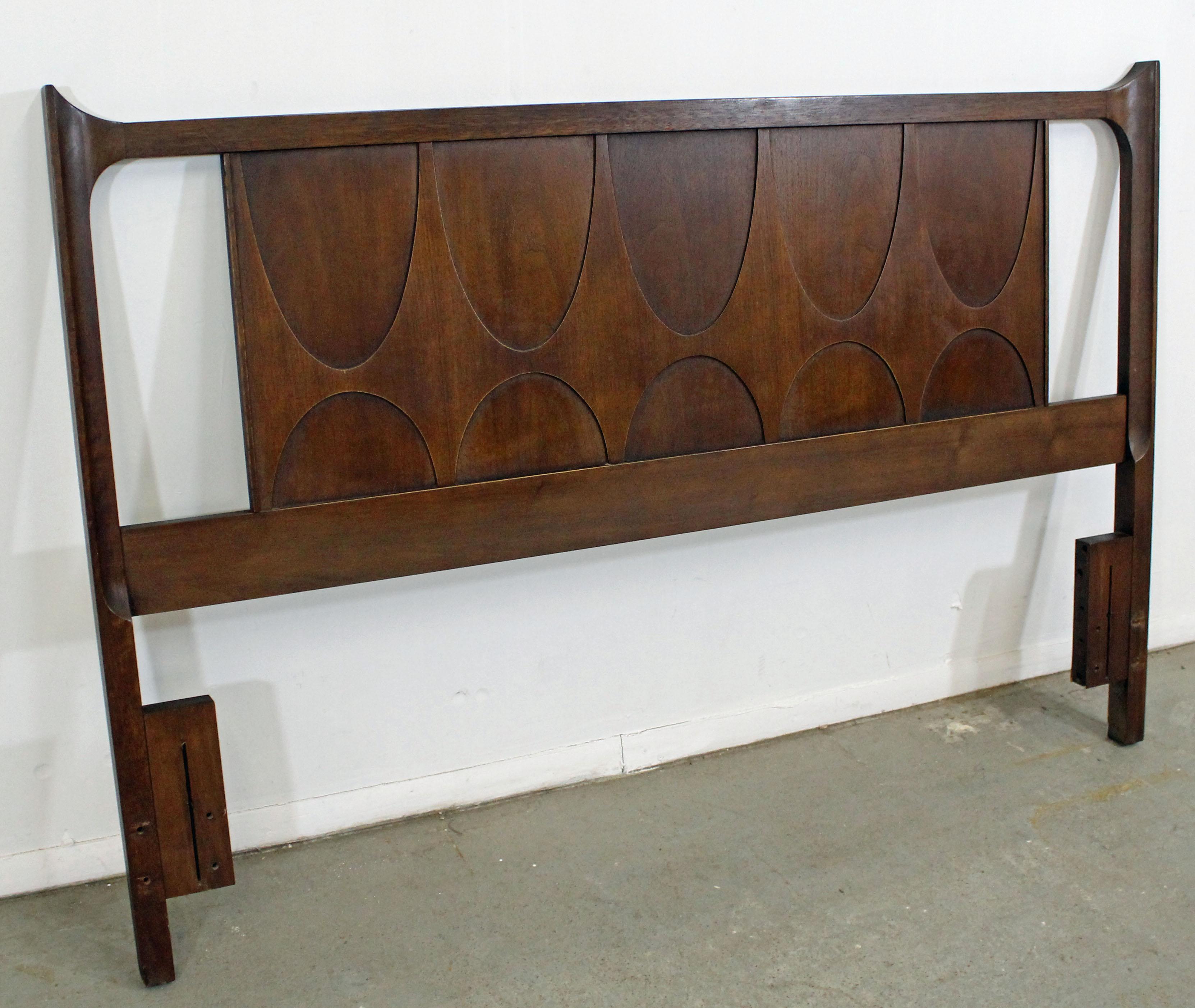 Offered is a Mid-Century Modern full/queen size headboard by Broyhill Brasilia. It is made of walnut and fits a full size mattress, but can also fit a queen with some modifications. The piece is in very good condition for its age, shows minor wear