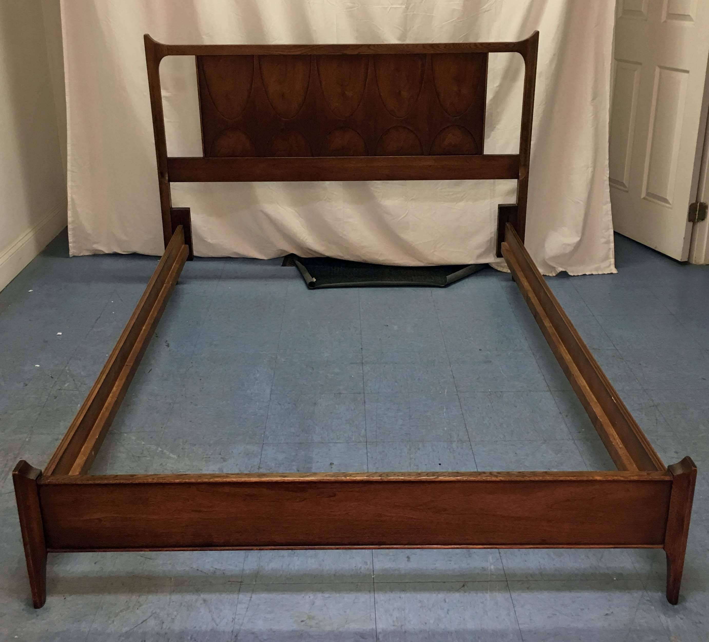 This bed is made from walnut and fits a full-size mattress. It was made for Broyhill's 'Brasilia' line. 

Dimensions:
Assembled: 60