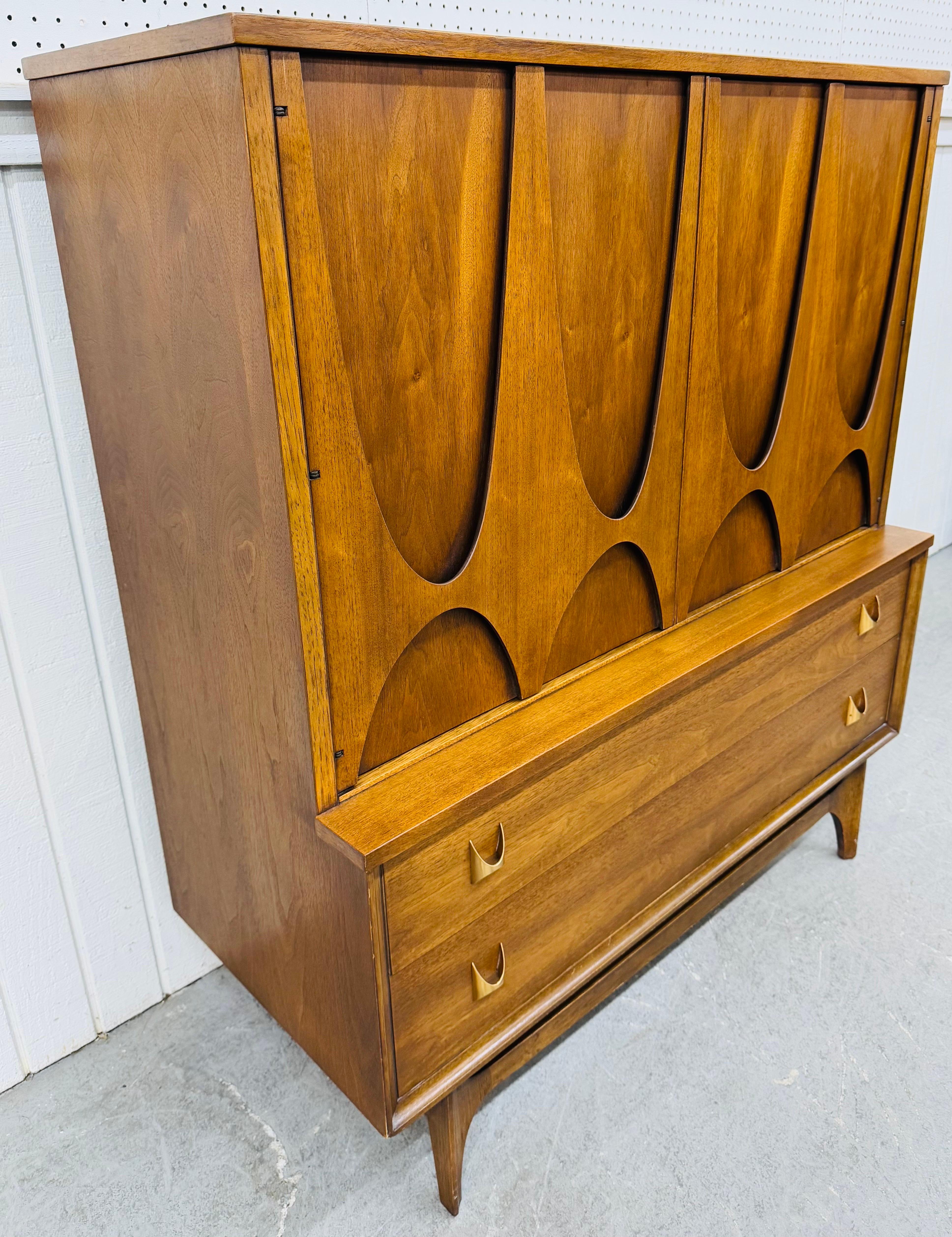 Diese Auflistung ist für eine Mid-Century Modern Broyhill Brasilia Walnuss High Chest. Mit einem geradlinigen Design, zwei großen Türen mit den ikonischen Brasilia-Zügen, Regalfächern/Schubladen im Inneren, zwei größeren Schubladen am Boden mit
