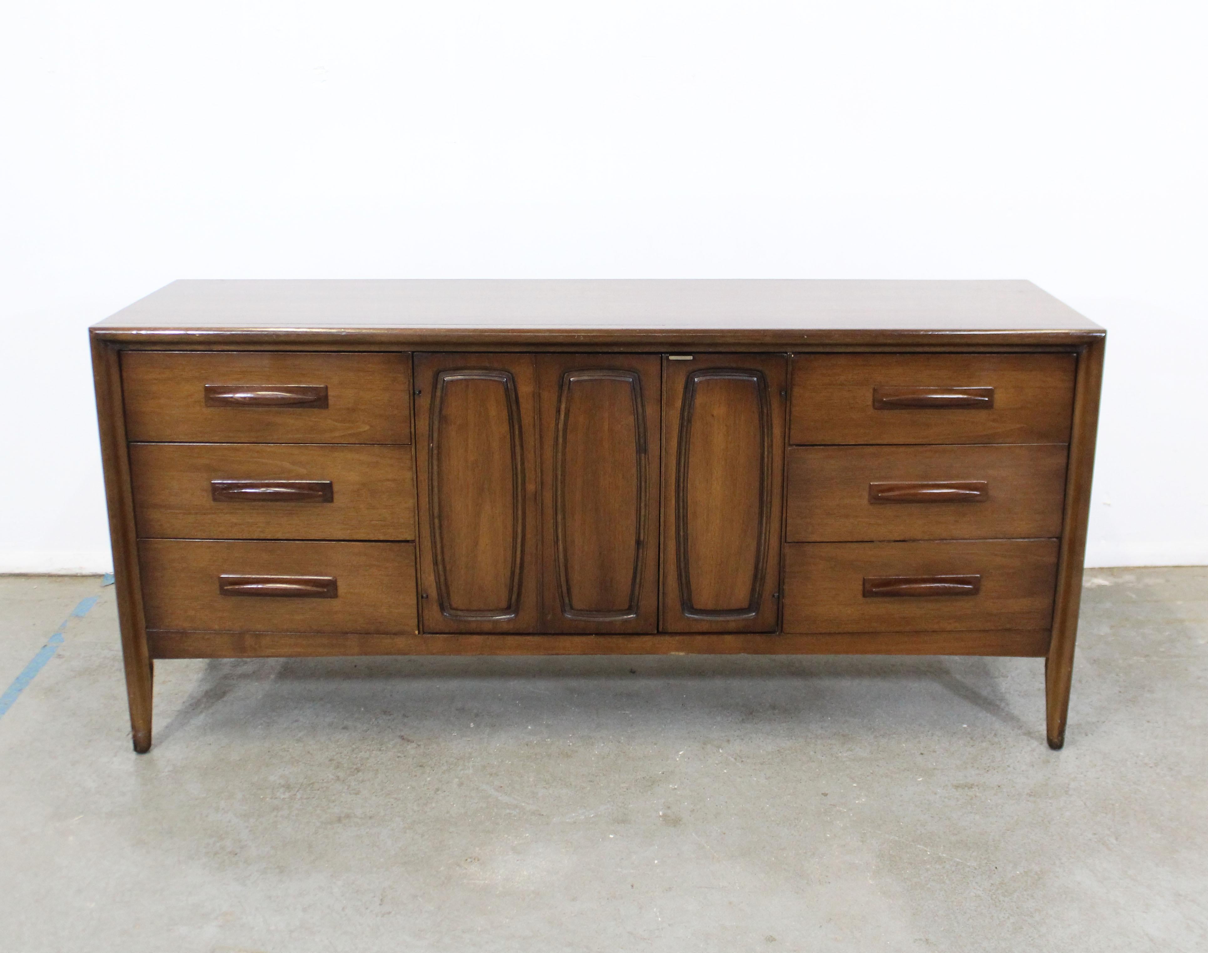 Offered is a vintage midcentury walnut credenza by Broyhill 