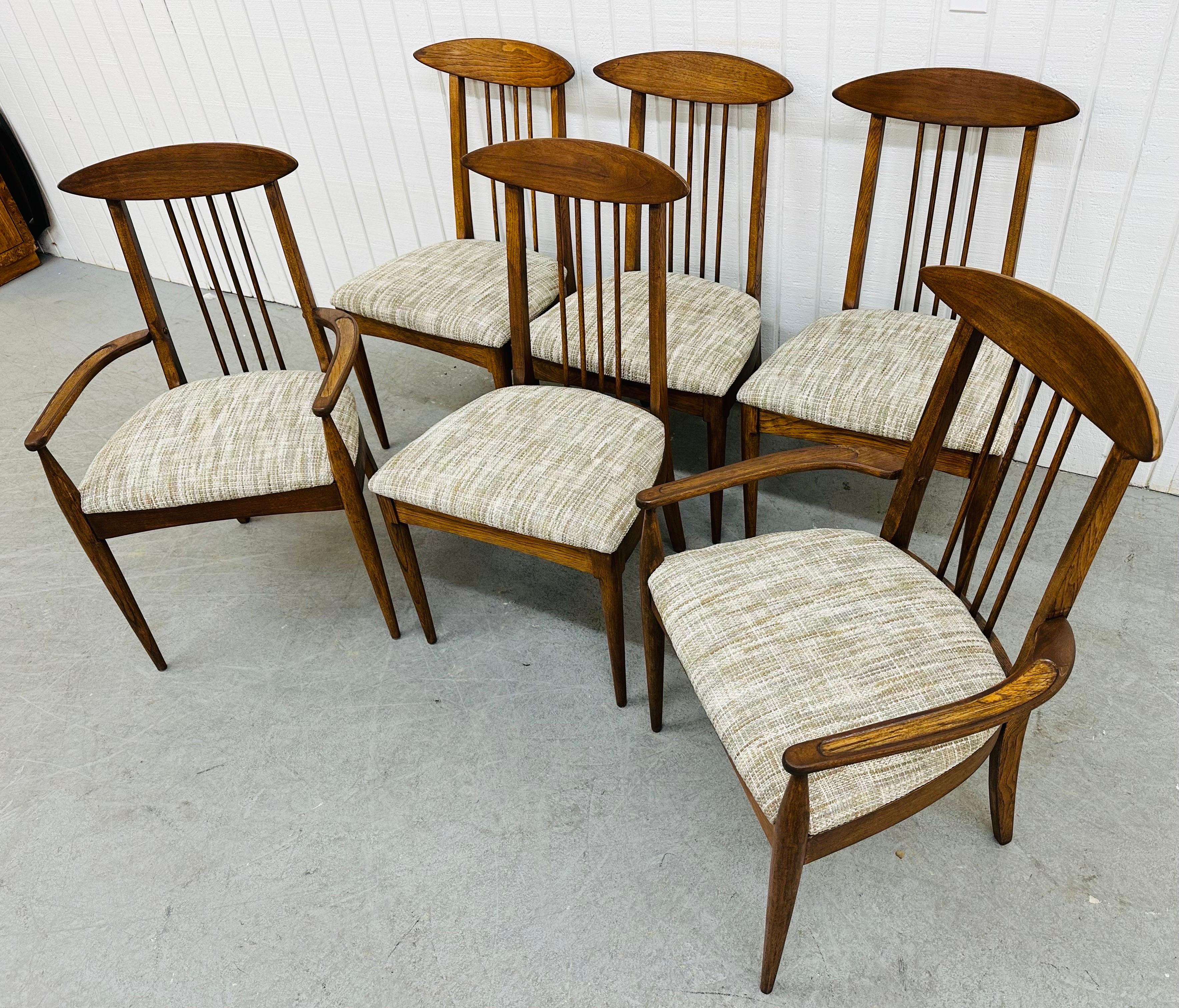 This listing is for a set of six Mid-Century Modern Broyhill Sculptra Walnut Dining Chairs. Featuring a comb back design, two arm chairs, four straight chairs, new upholstered seats, and a beautiful walnut finish. This is an exceptional combination
