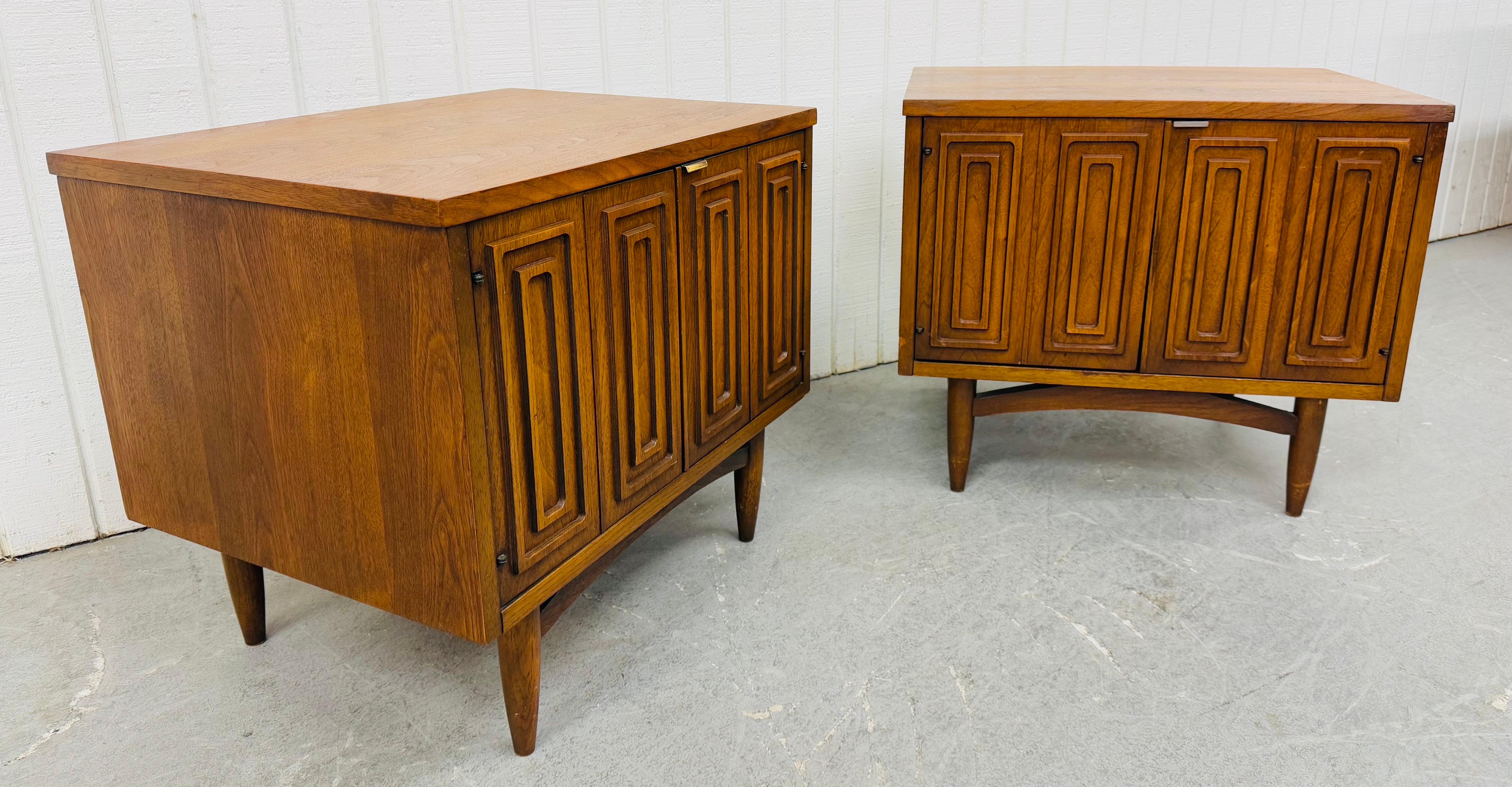 This listing is for a pair of Mid-Century Modern Broyhill Sculptra Walnut Nightstands. Featuring a straight line design, two doors that open up to storage space, modern legs, and a walnut finish. This is an exceptional combination of quality and MCM