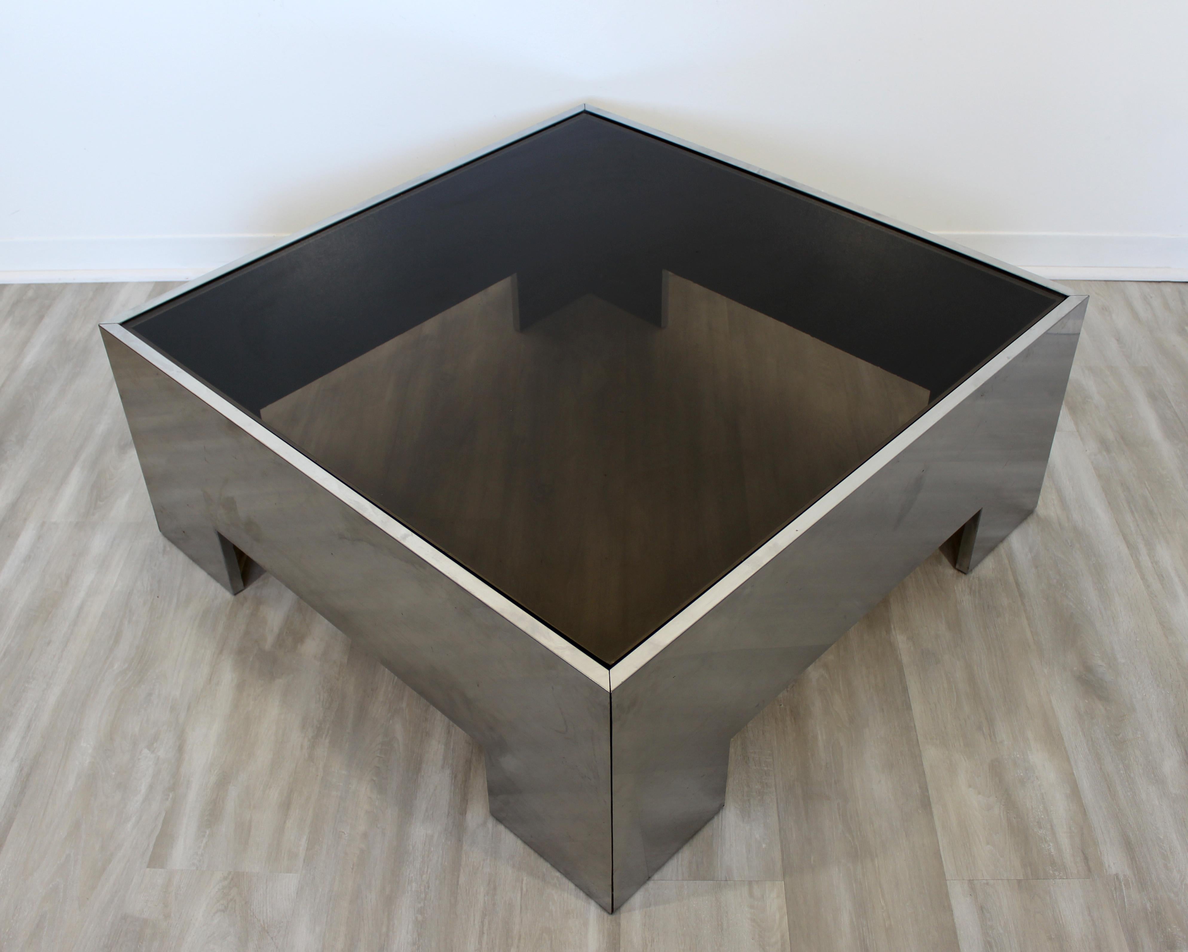 For your consideration is a fantastic, square coffee table, with a smoked glass top on a brushed aluminum base, circa the 1970s. Attributed to Brueton or Pace. In excellent vintage condition. The dimensions are 38