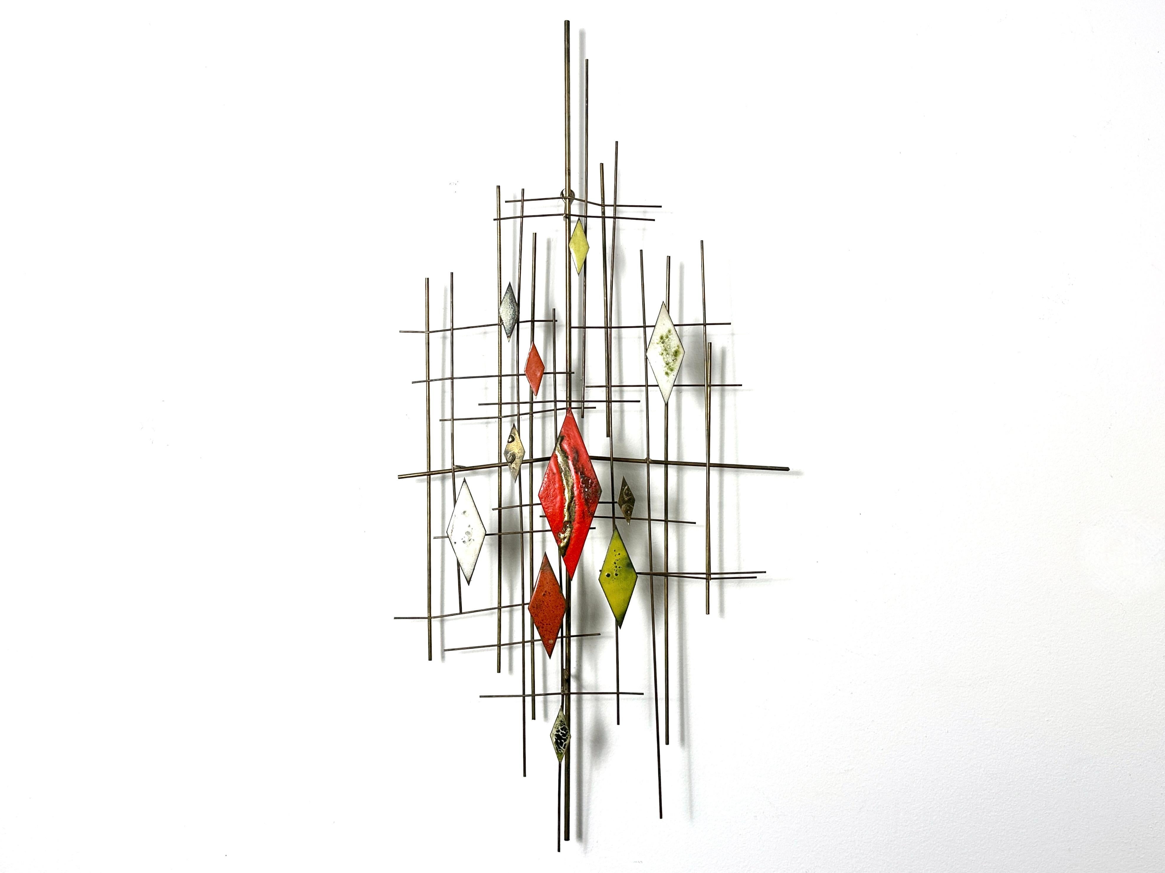 Original Mid Century modern wall sculpture attributed to Santora circa 1960s
Gold wire dimensional construction with red yellow and white enamel accents