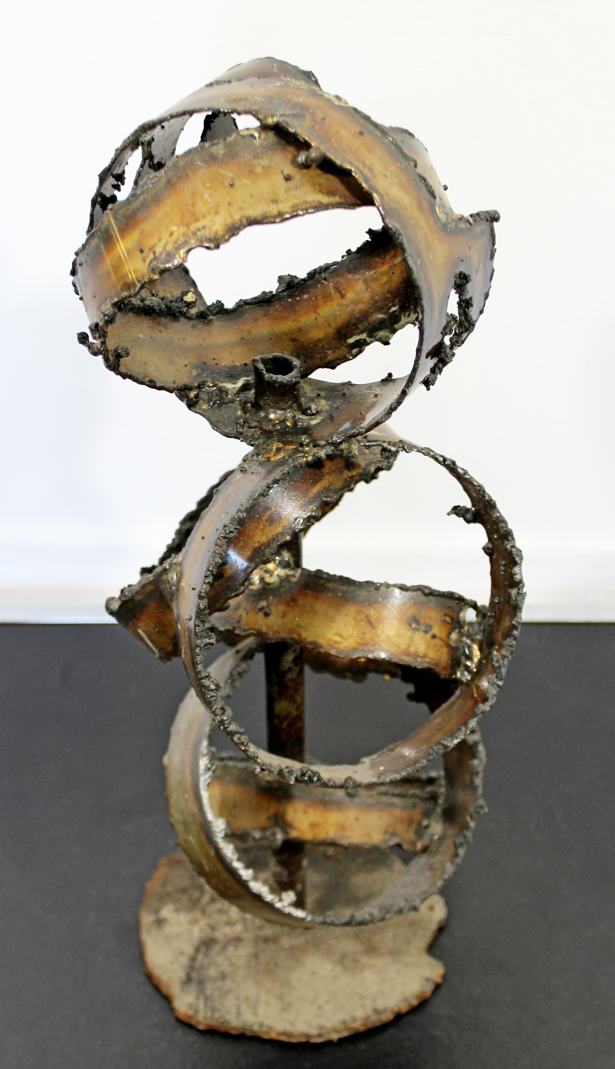 For your consideration is a riveting, Brutalist, abstract, torched metal art table sculpture, circa 1970s. In excellent condition. The dimensions are 8