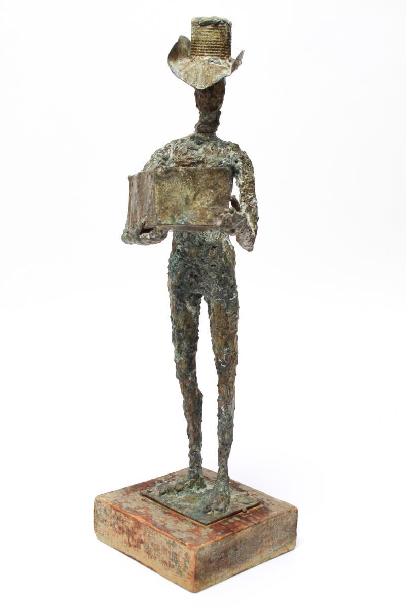 Mid-Century Modern Brutalist green-patinated bronze sculpture of a cowboy holding up a box, mounted on a wood base. The head appears to have been cast separately and attached. Some wear to the paint on the base.