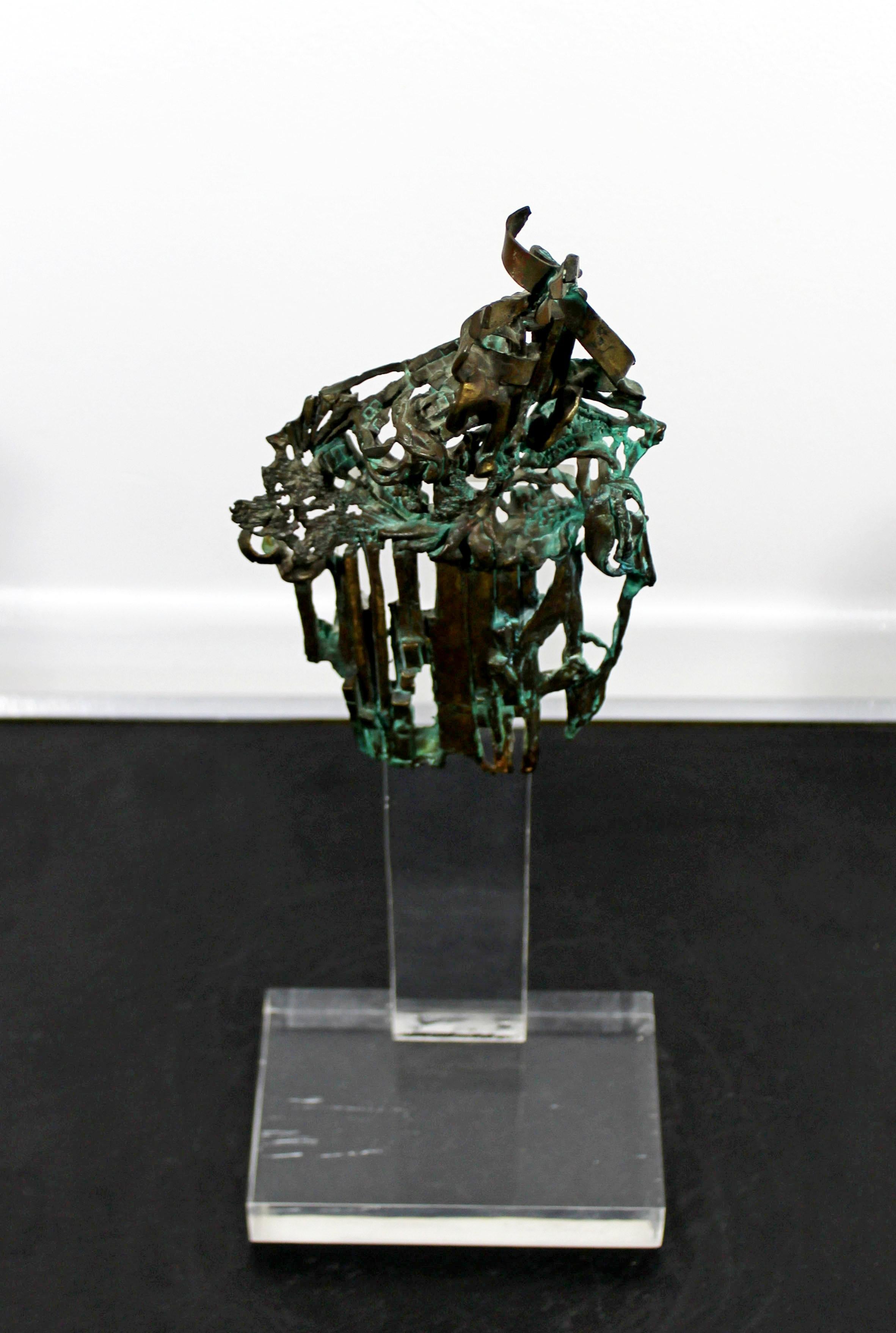 For your consideration is a brilliant, Brutalist, abstract, bronze table sculpture on a clear acrylic Lucite base, signed Glen Michaels, circa 1970s. In excellent condition. The dimensions are 6