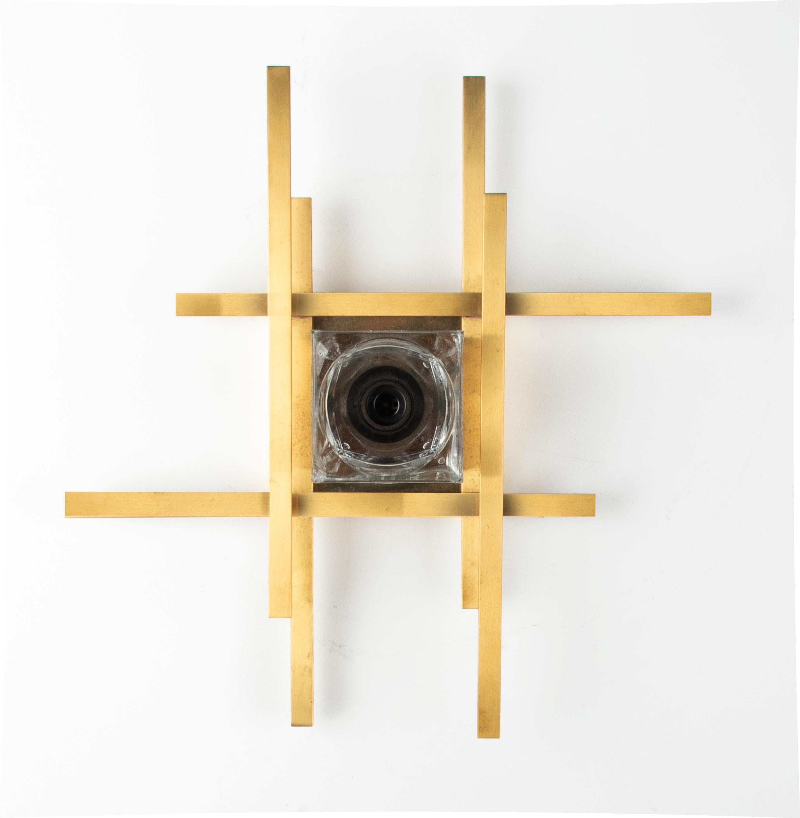 A sculptural brutalist wall light by Gaetano Sciolari, made in 1960-1970, Italy. Brass fixture, ice cubic shaped glass shade is made of Murano glass. The geometric design is a variation of Sciolari`s classic 