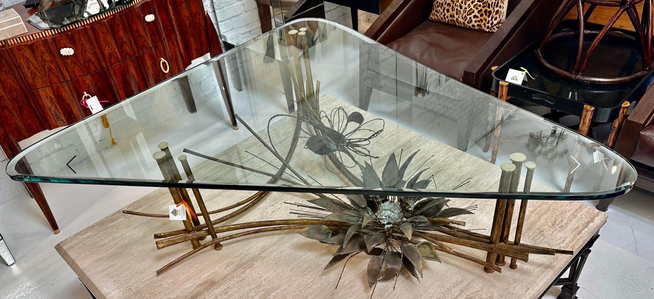 Incredible Brutalist Brass Based Cocktail or Coffee Table, Midcentury Modern. It has an unusual form with an abstract insect and flower base with a faux bamboo frame. The reverse beveled glass top with a custom form.