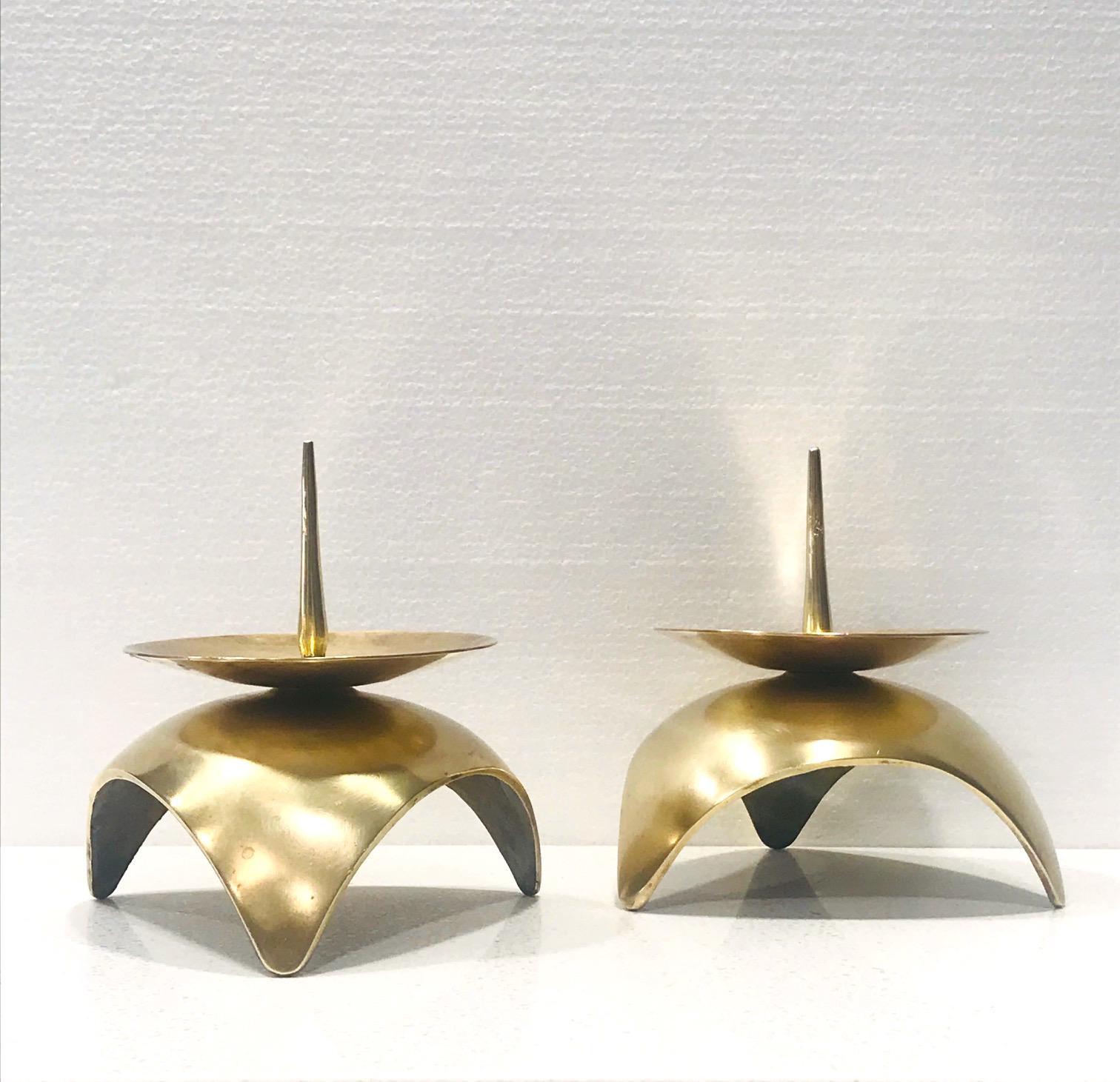Pair of Japanese Mid-Century Modern candleholders in solid brass metal. Candlesticks have a Brutalist inspired design with spherical base and stylized spike and center dish. Ultra modern and gorgeous from all angles.