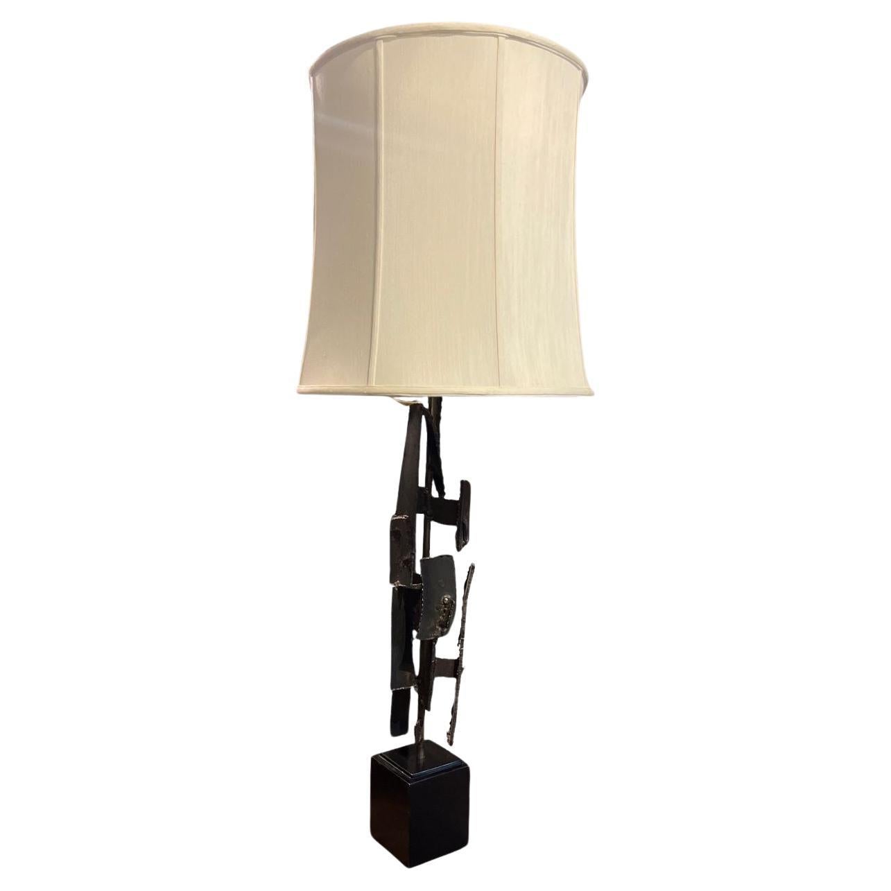Stunning mid-century Brutalist lamp by Richard Barr for Laurel Lamp Company. A handsome large torch-cut iron table lamp, it is a Mid-Century Modern classic. Dimensions without shade 43 inches high, 5 by inches square. Dimensions with the shade 48