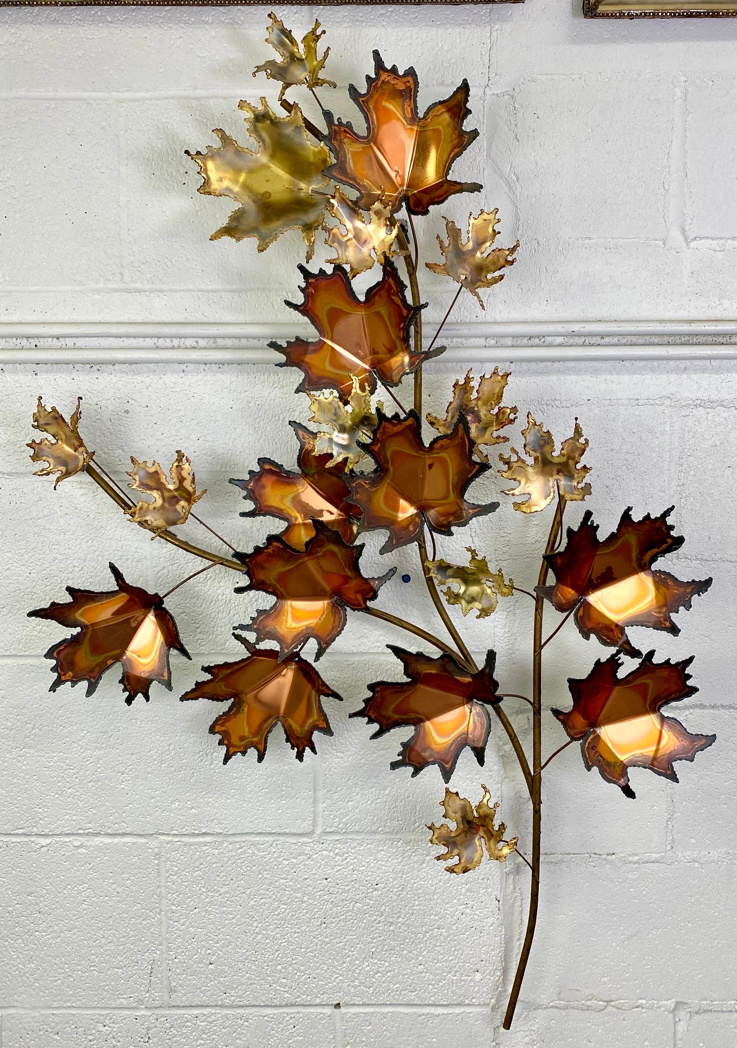 A beautiful Mid-Century Modern maple leaf design wall sculpture by Curtis Jere. The brutalist style leaf is handmade of quality bronze and brass. The large wall decor MCM sculpture shows beautiful patina on each leaf adding charm and elegance to its