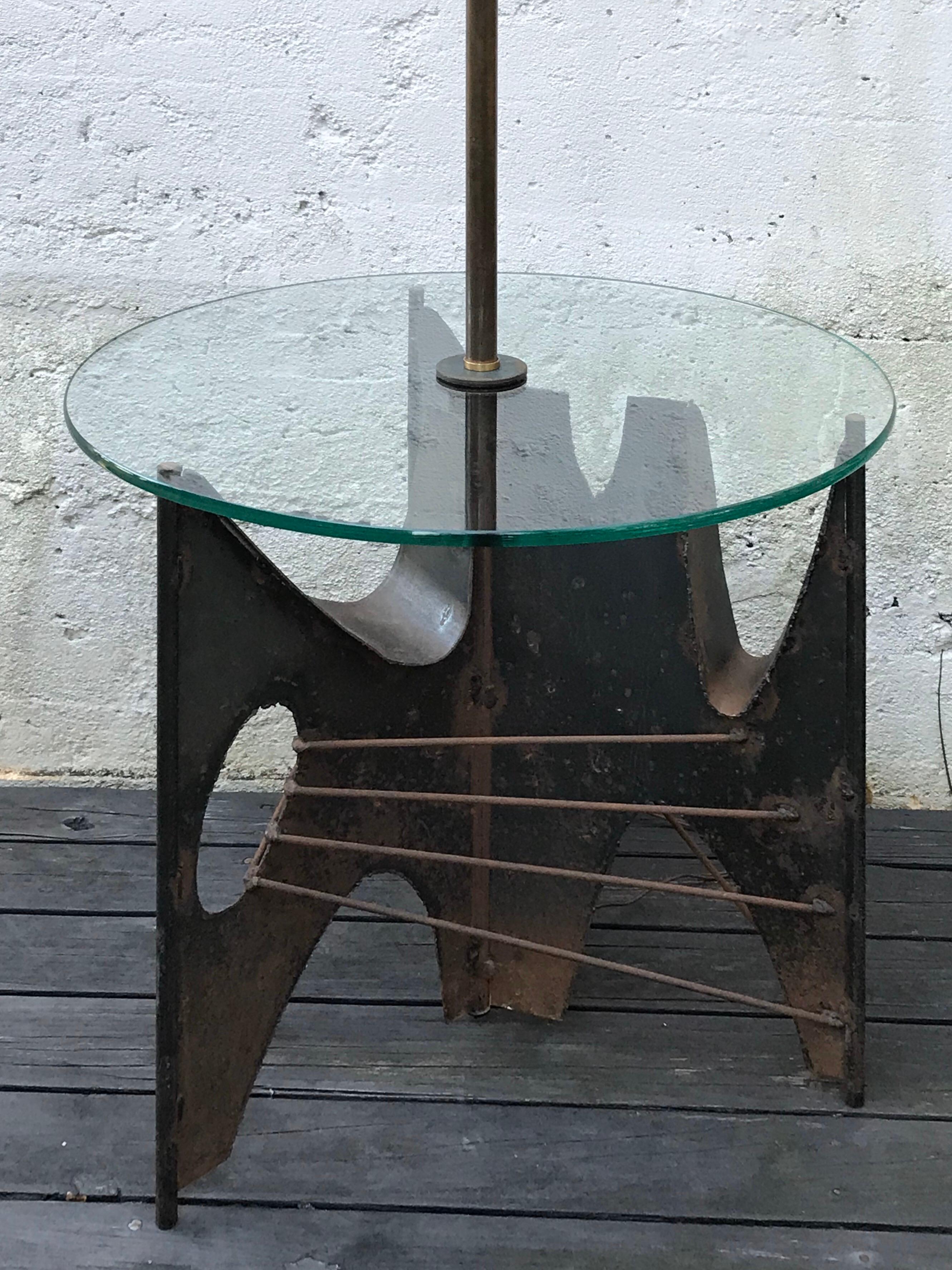 Very cool Brutalist sculptural floor lamp by Richard Barr for Laurel Lamp Co.  Welded metal base with aged patina, clear round glass table top.
Shade not included.
