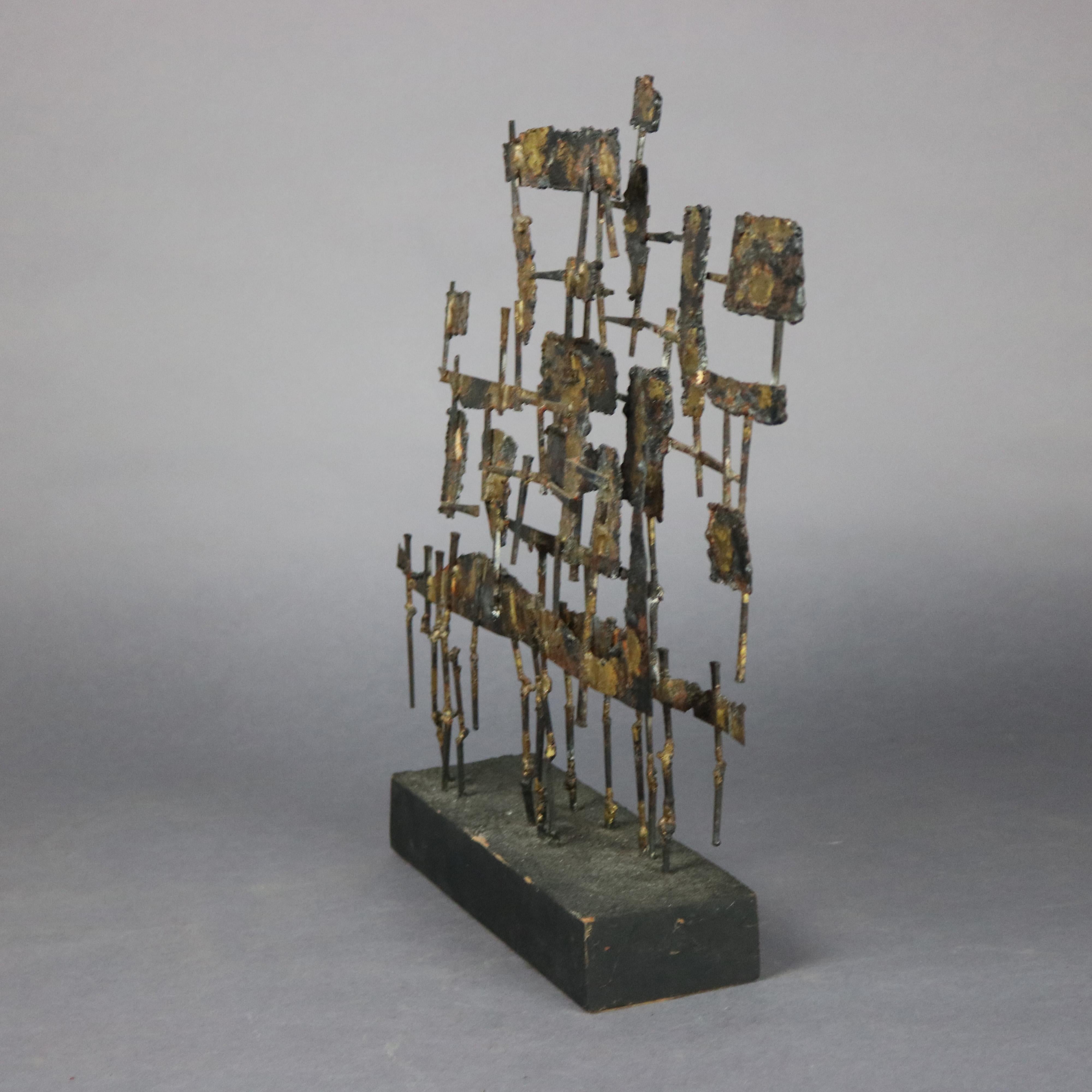 A Mid-Century Modern Brutalist sculpture offers metal construction with raised geometric elements, unsigned, circa 1960.

Measures: 17.75
