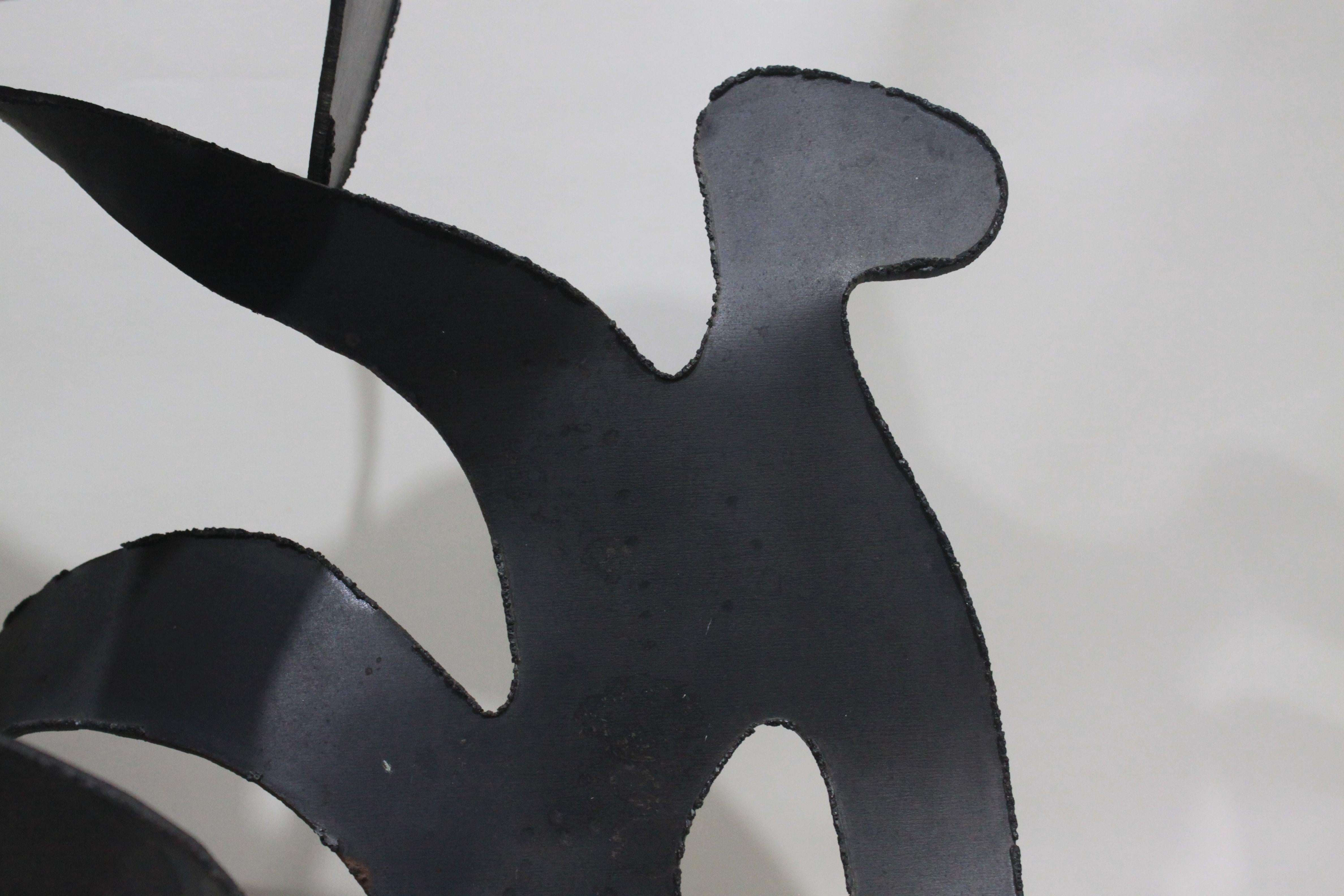 This large and unique wall sculpture is unsigned, but presumed to have been made in the United States. Done in the 1960s, this Mid-Century Modern metal is artisan made using plate steel, and cut, hammered and formed to create a three dimensional