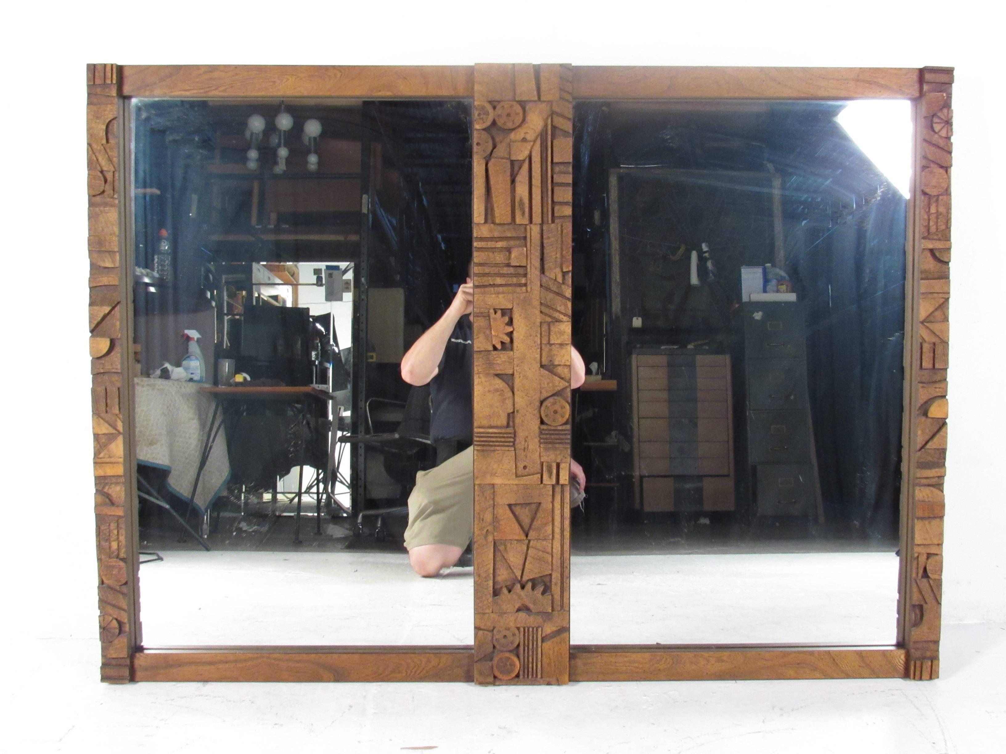This impressive vintage modern mirror features a Brutalist design in the center. A wonderful and unique piece that can be used as a wall mirror or attached to the back of a credenza. Extremely thick walnut wood designed by Lane Furniture. Please