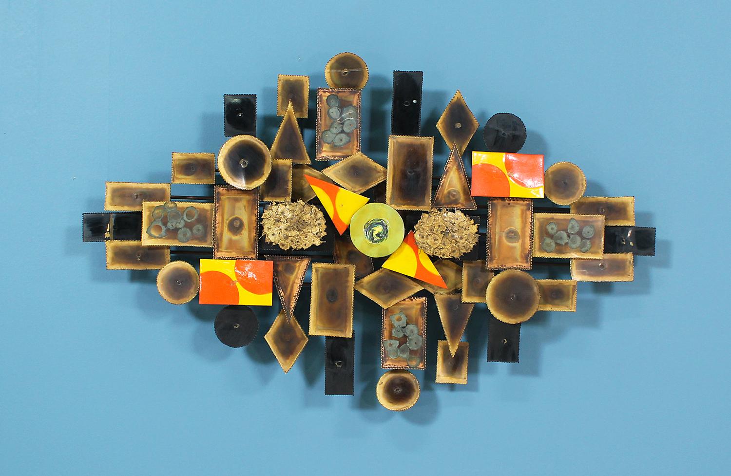 Mid-Century Brutalist wall sculpture designed and manufactured circa 1960’s. This unique wall art can be hung by both horizontal or vertical orientations. The various geometric shapes are made of bronze and copper and connected by a fine brass